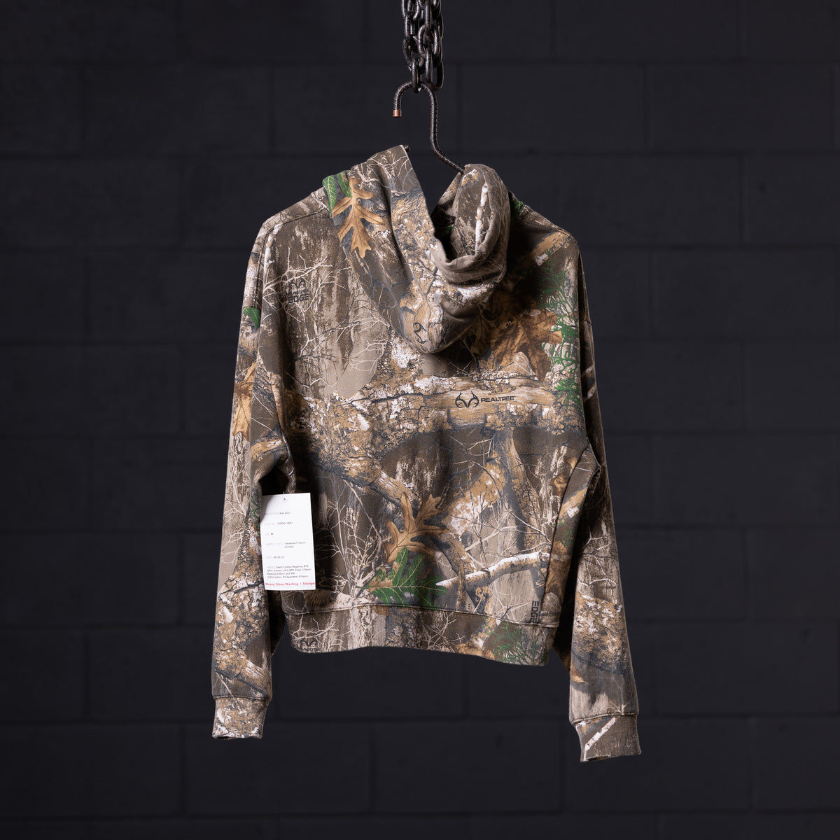 Distressed Warmup Zip Hoodie in camo brown, displayed on hanger against dark background