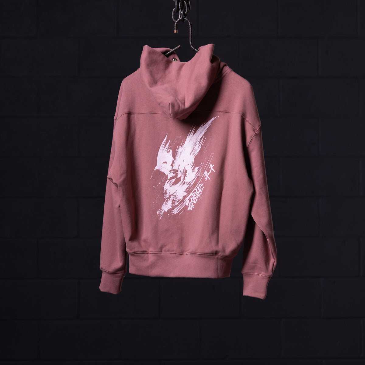 FA'22 Tech Terry Eagle Hoodie in mauve pink, hung on display with white graphic print visible