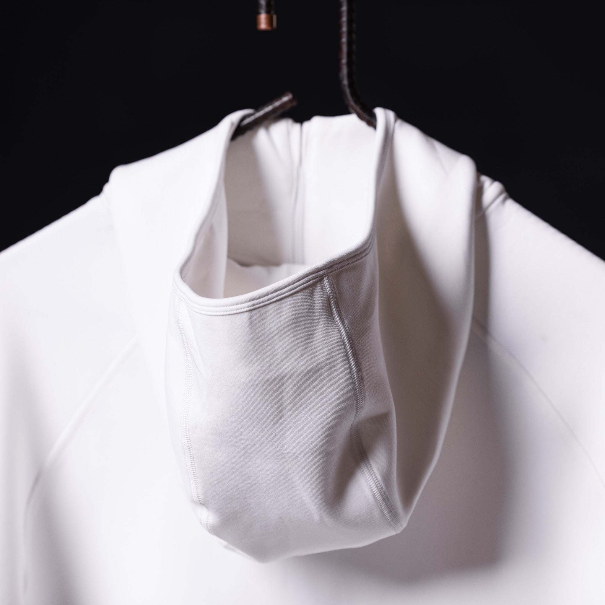 2019 Scuba Hoodie in white, displayed on hanger showing front pouch detail