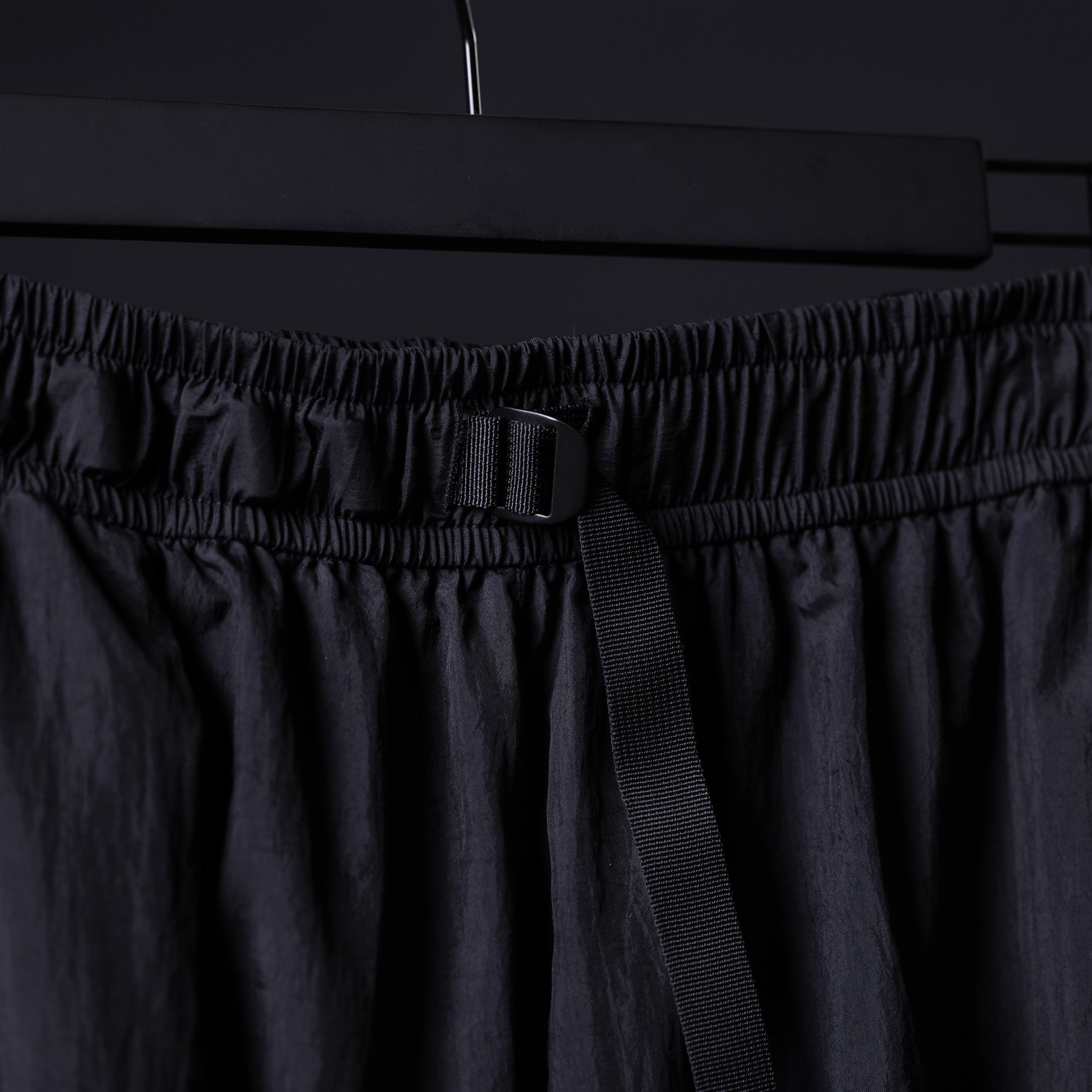 2021 Oversized Track Pant in black, detail shot of waistband and drawcord