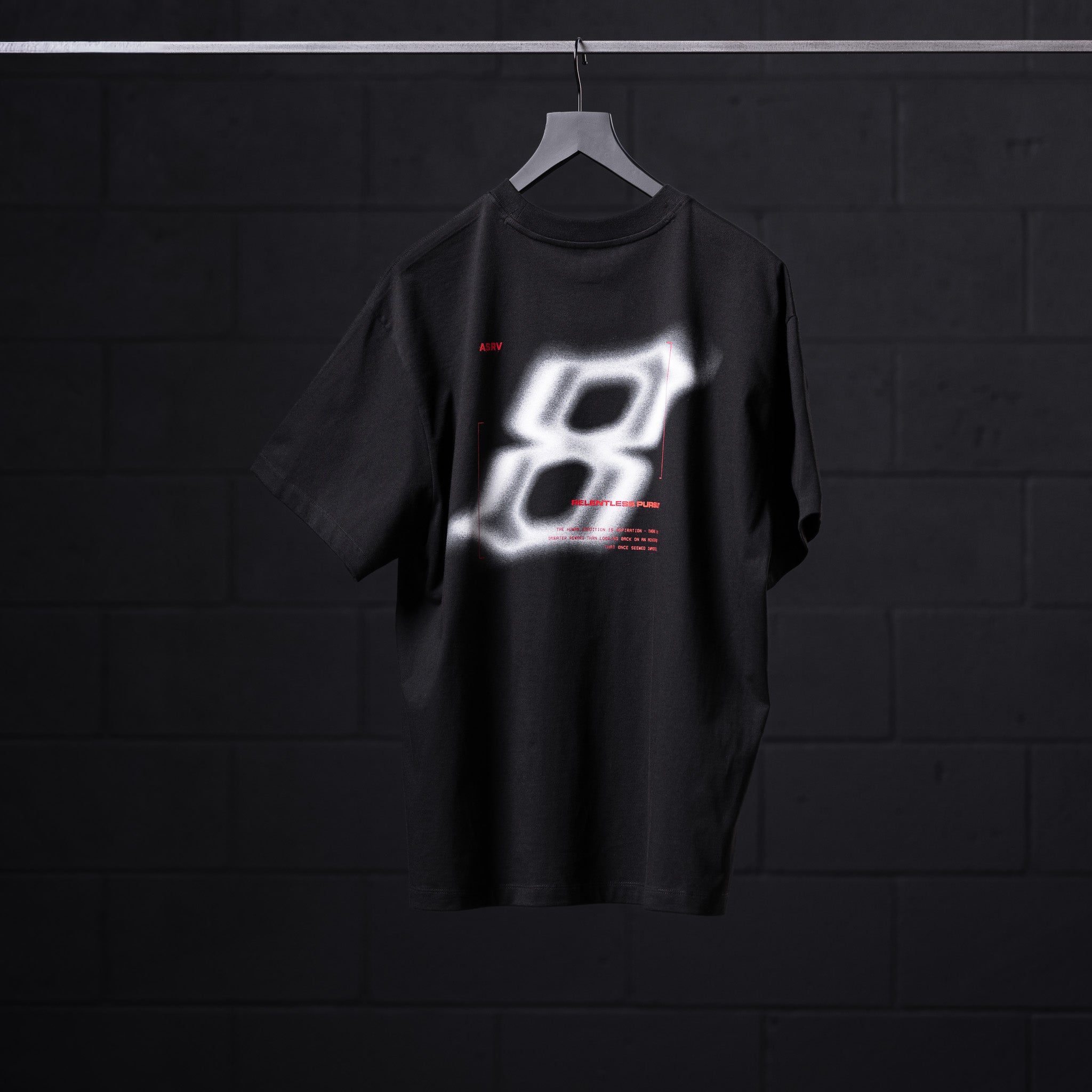 Black Tech Essential Relaxed Tee with glowing graphic design on hanger, front view