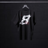 Black Tech Essential Relaxed Tee with glowing graphic design on hanger, front view