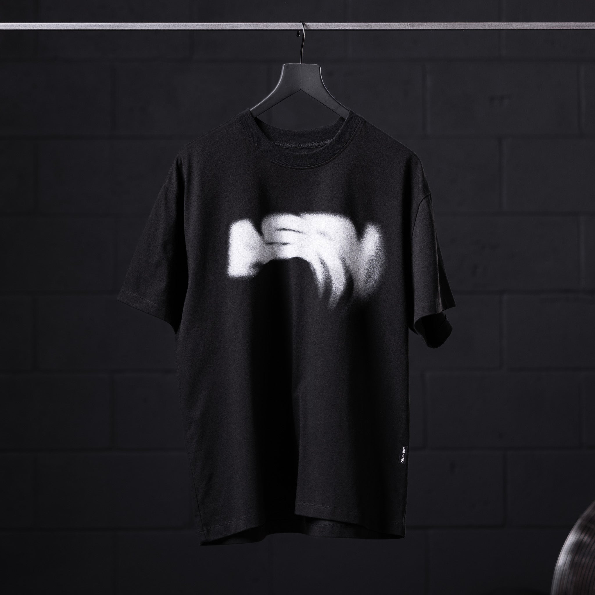 Black Tech Essential Relaxed Tee with 'Signal Lost' graphic design on hanger