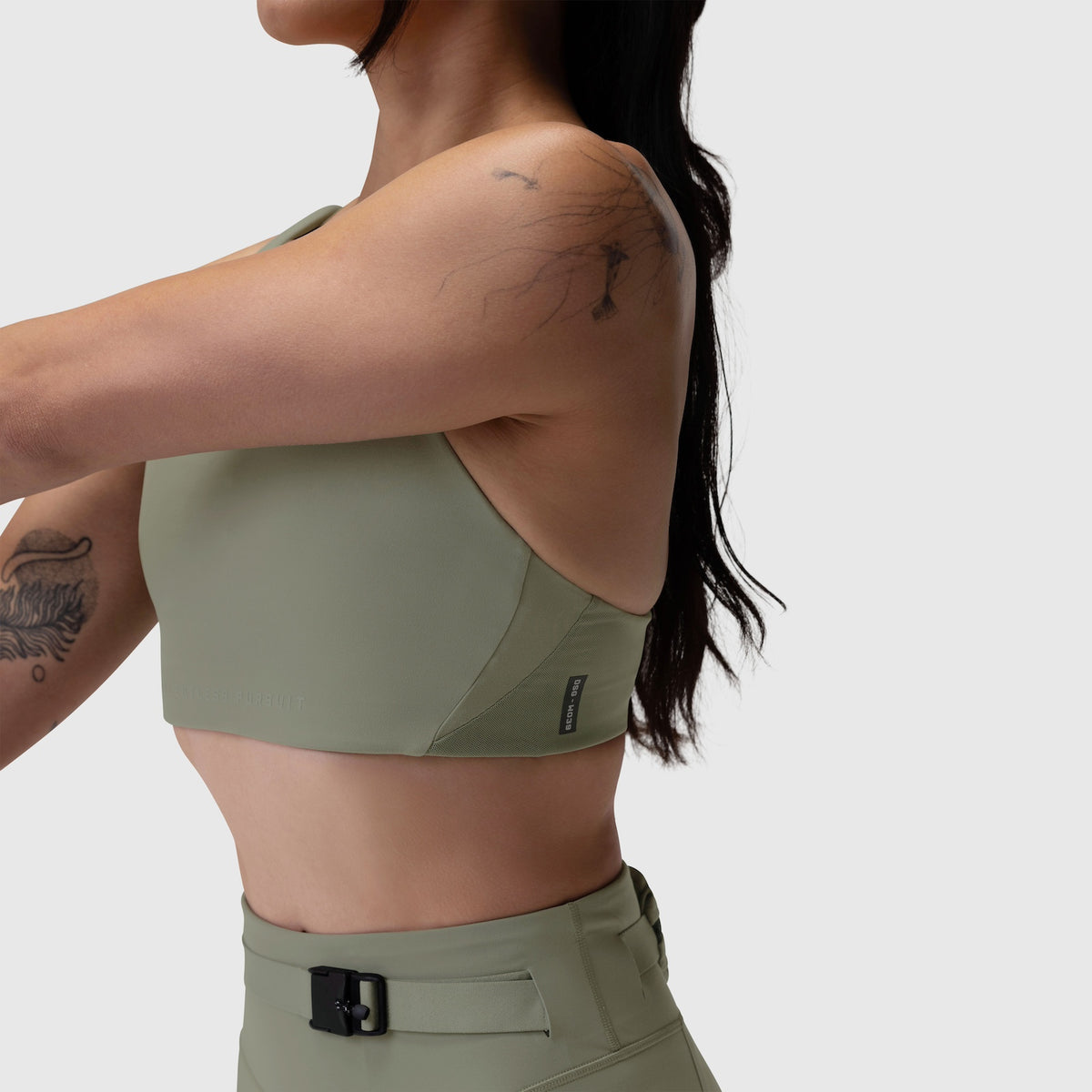 Sage LYCRA® Hybrid Sports Bra worn by model shown from side back view