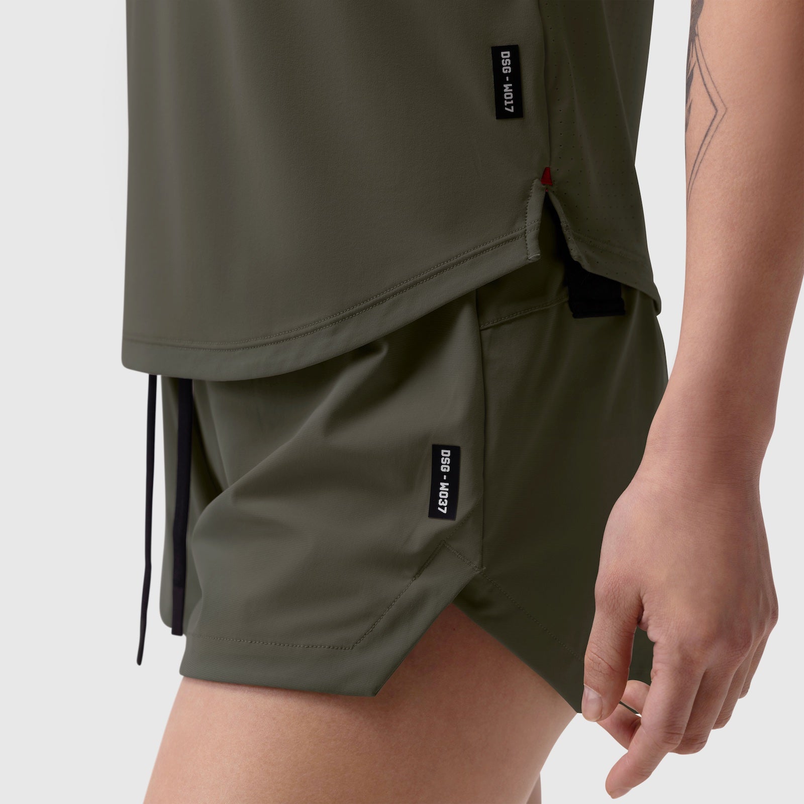 Laser-Vent Established Tee in olive worn by model, side detail view showing shorts