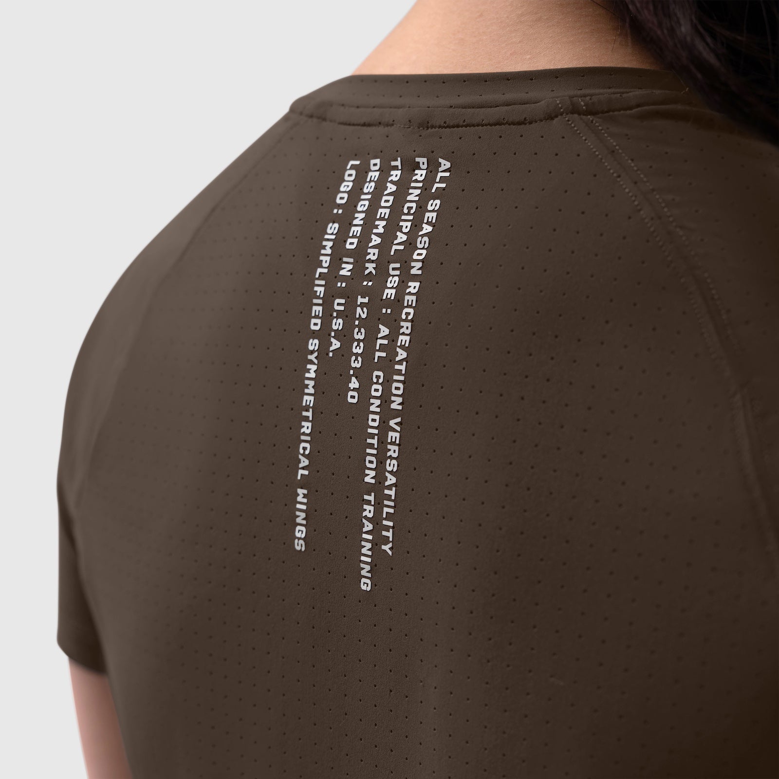 W017 Laser-Vent Established Tee in dark earth, back view on model showing text graphic