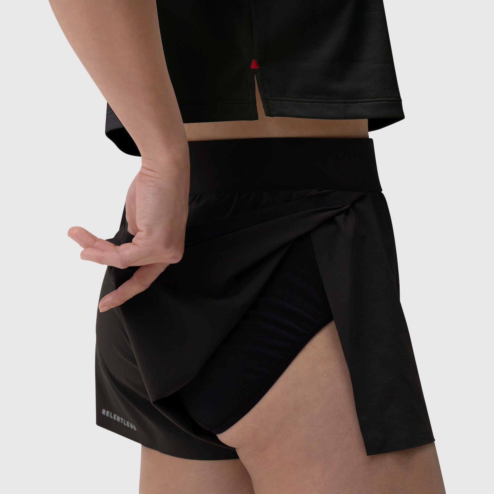 Aerotex Side Split Run Short in black, worn by model showing side split detail and pocket