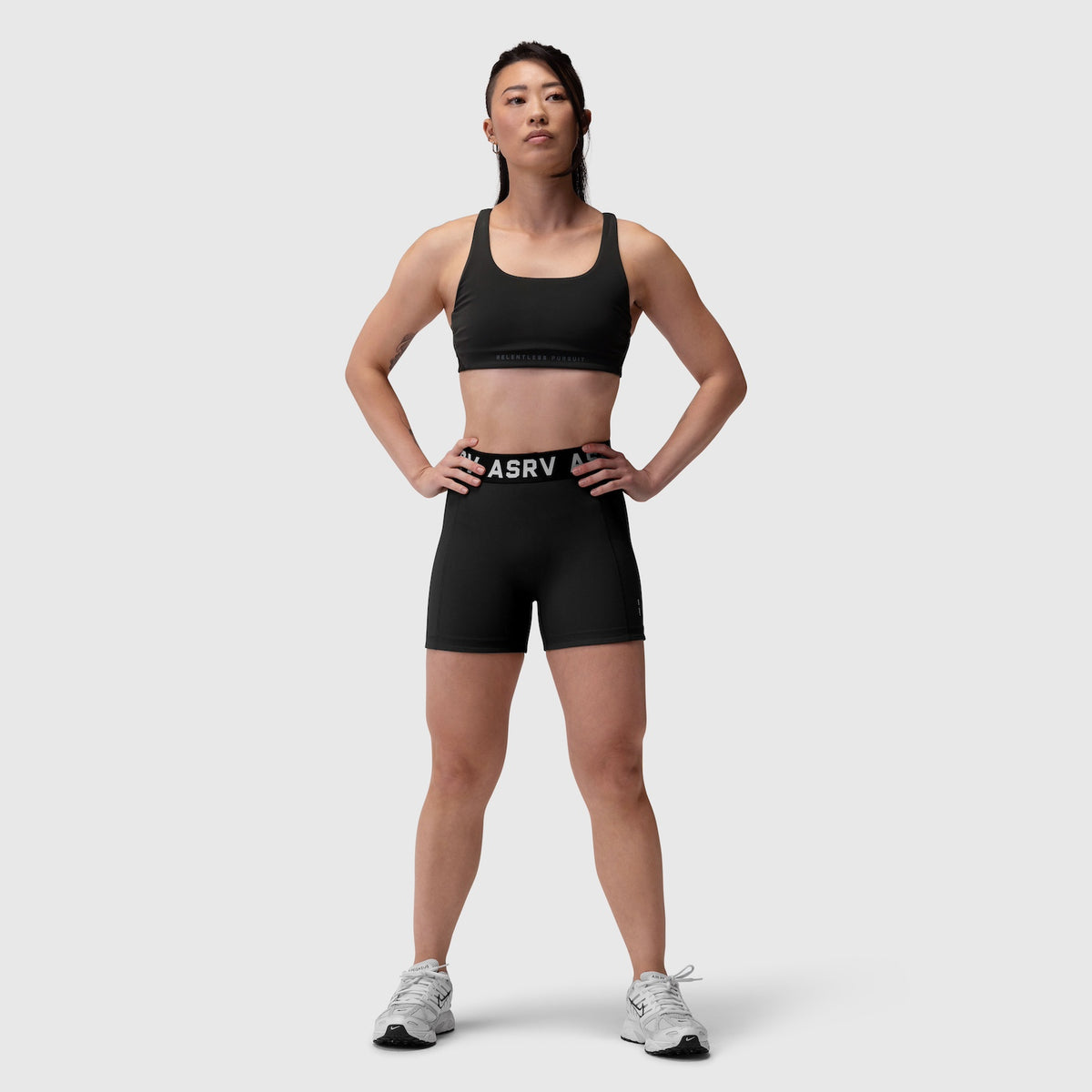 W039 Lycra Hybrid Sports Bra in black, worn by model standing facing forward