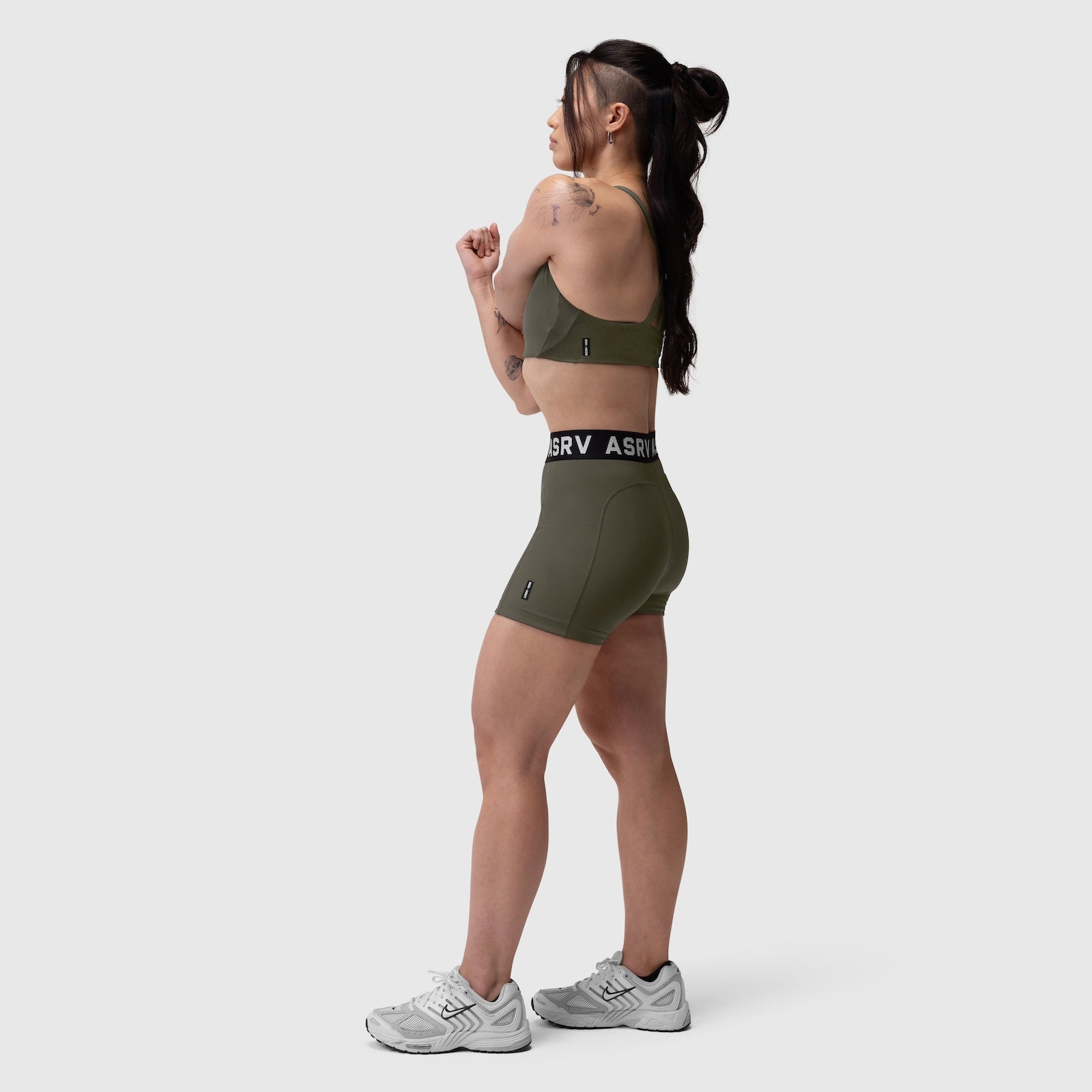 W039 Lycra Hybrid Sports Bra in olive, worn by model in side profile stance