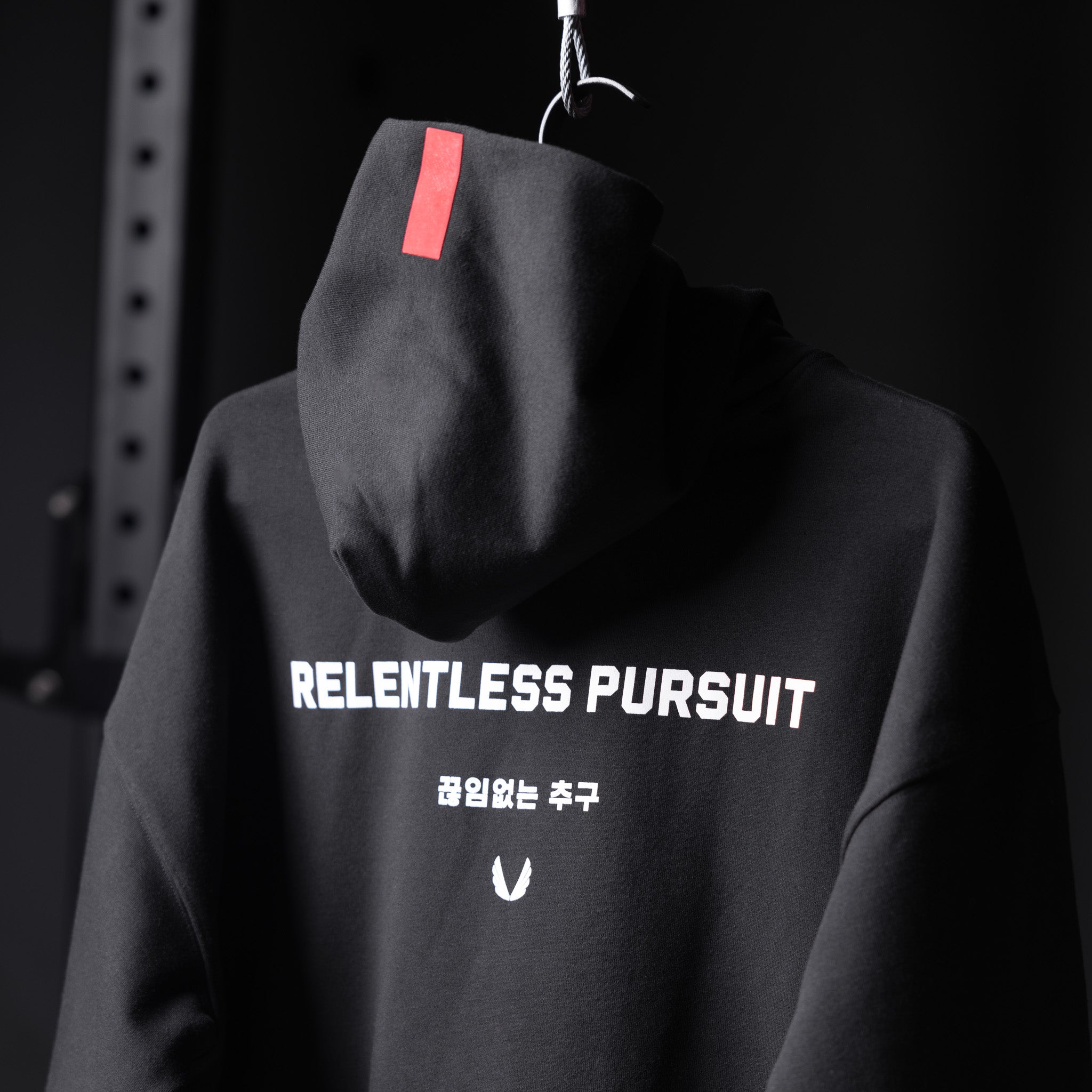 Tech-Terry Zip Pocket Hoodie in black with 'Relentless Pursuit' graphic, displayed on mannequin