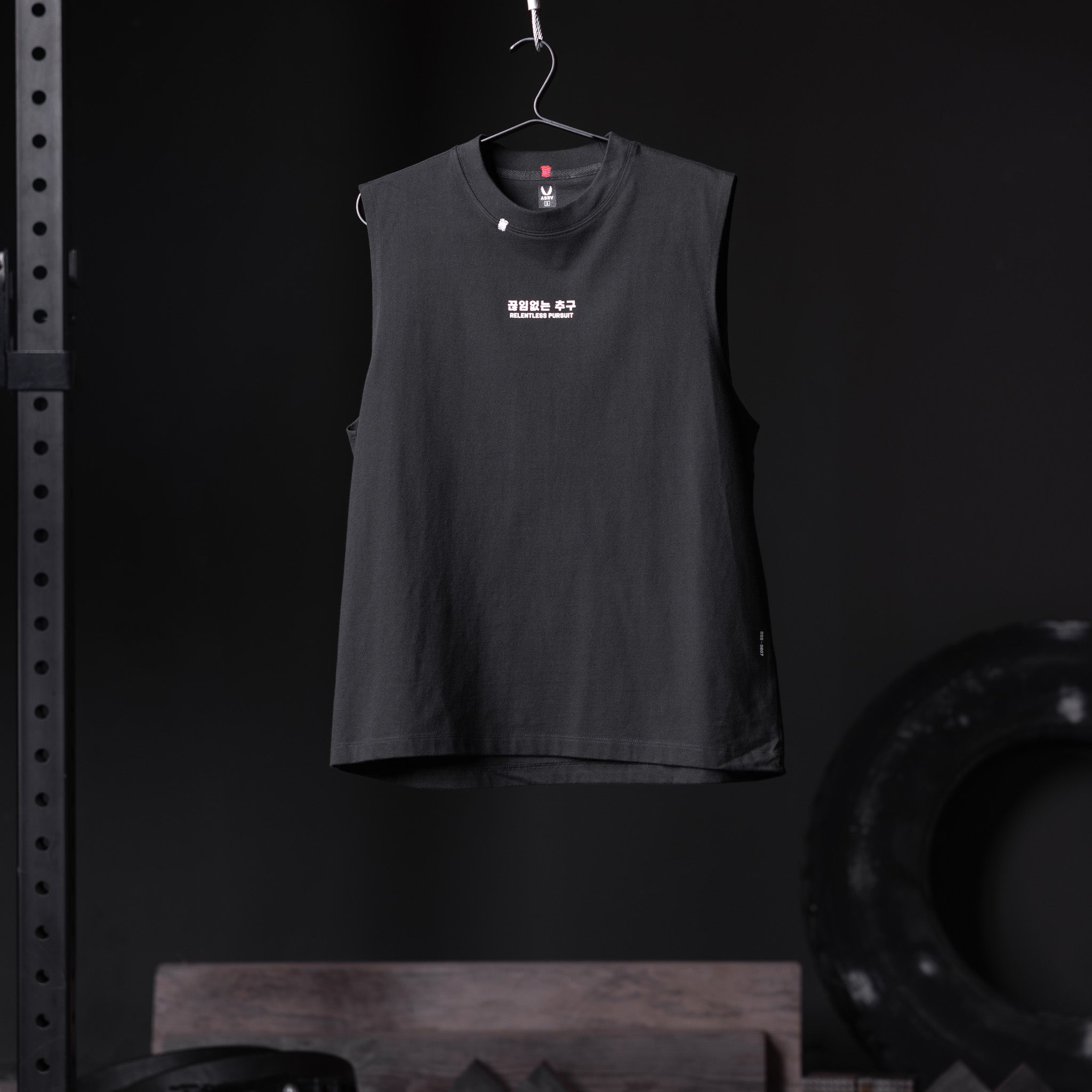 Black Tech Essential Relaxed Cutoff sleeveless tank on hanger, front view