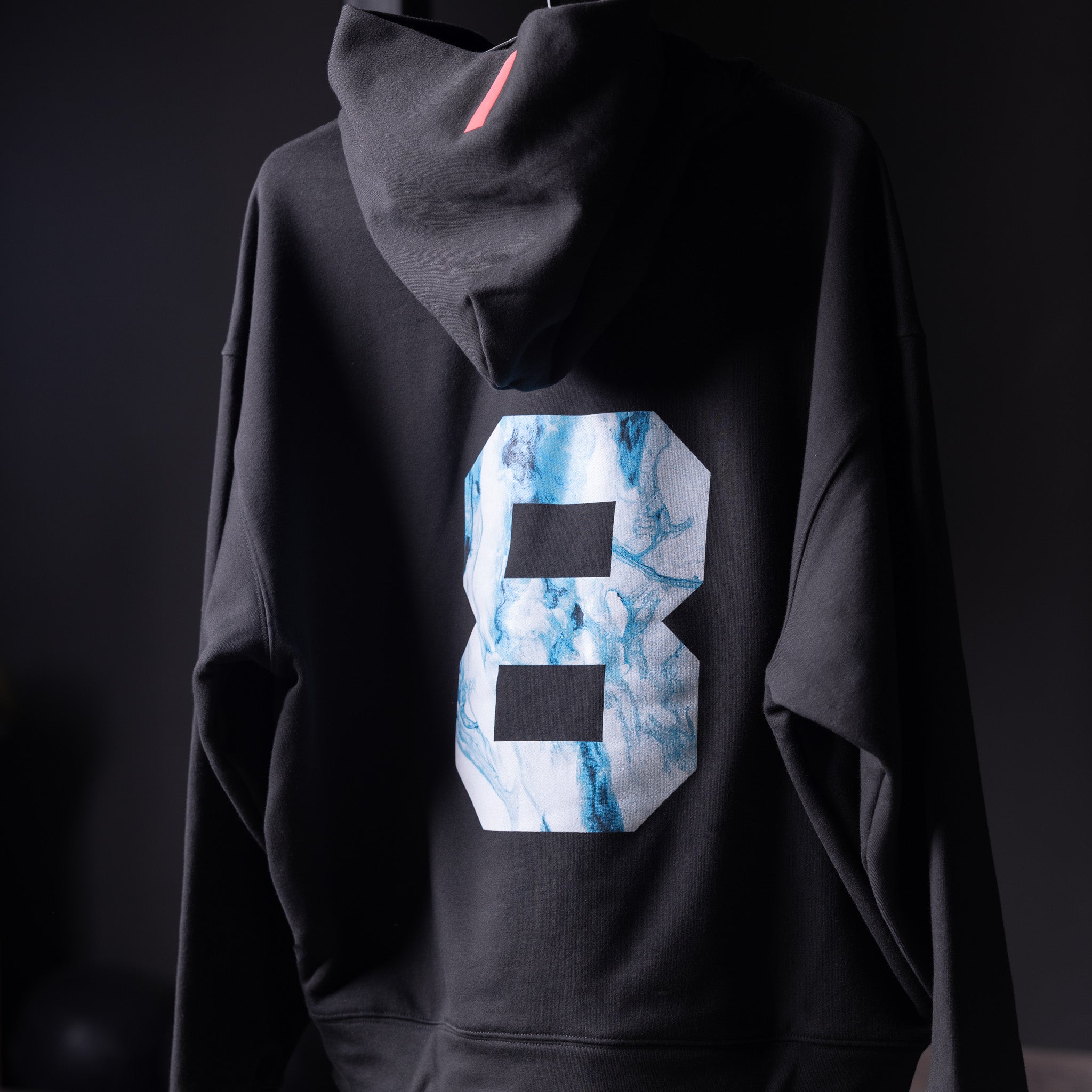 Tech-Terry Zip Pocket Hoodie in black with marble 8 graphic, worn by model