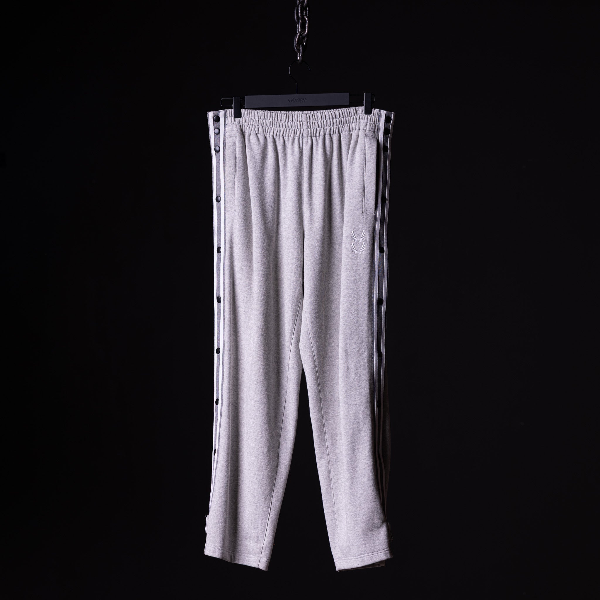 SP'22 Tearaway Jogger in light grey, displayed on hanger against black background
