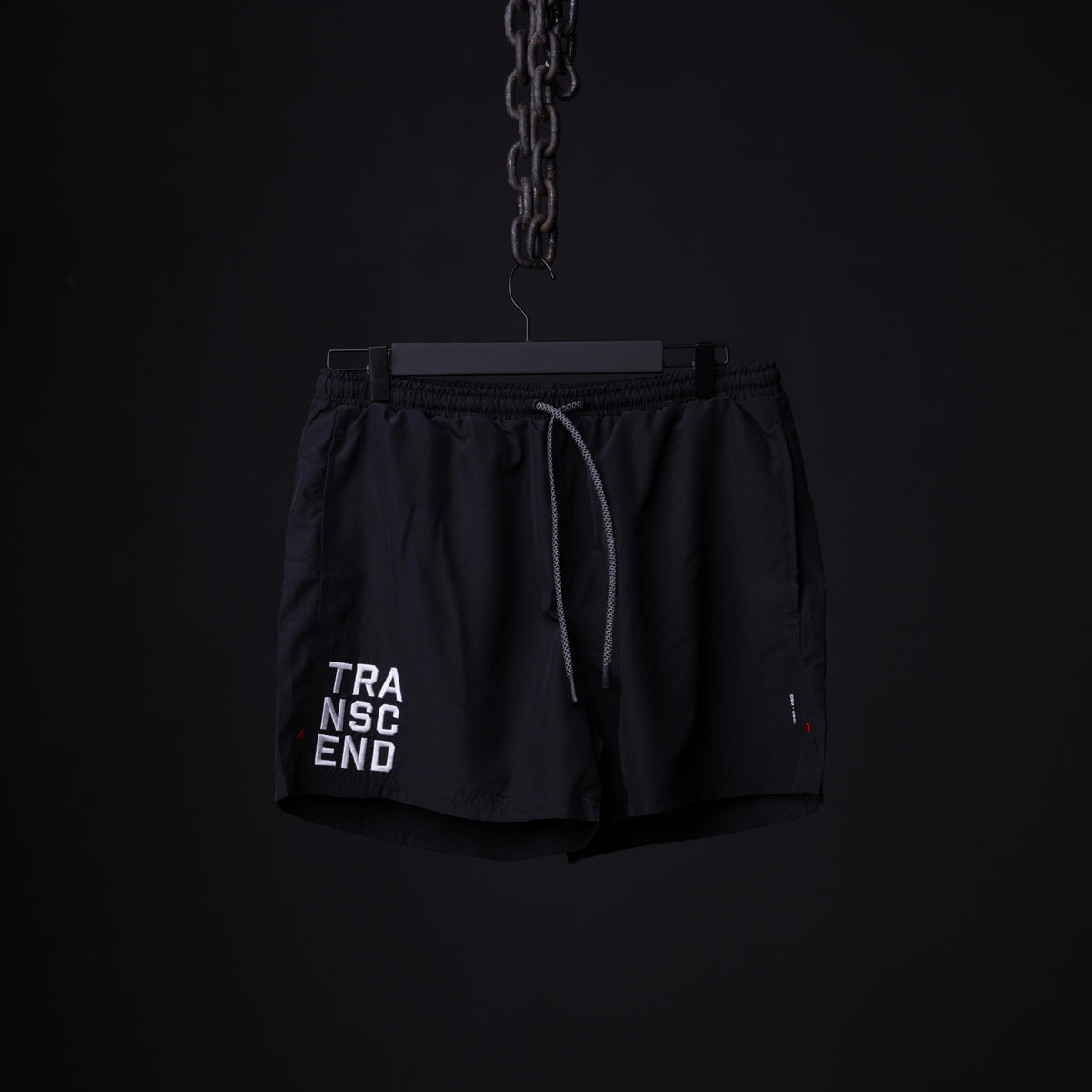 SP'22 Vintage 5" Training Short in black, hanging on chain against dark background