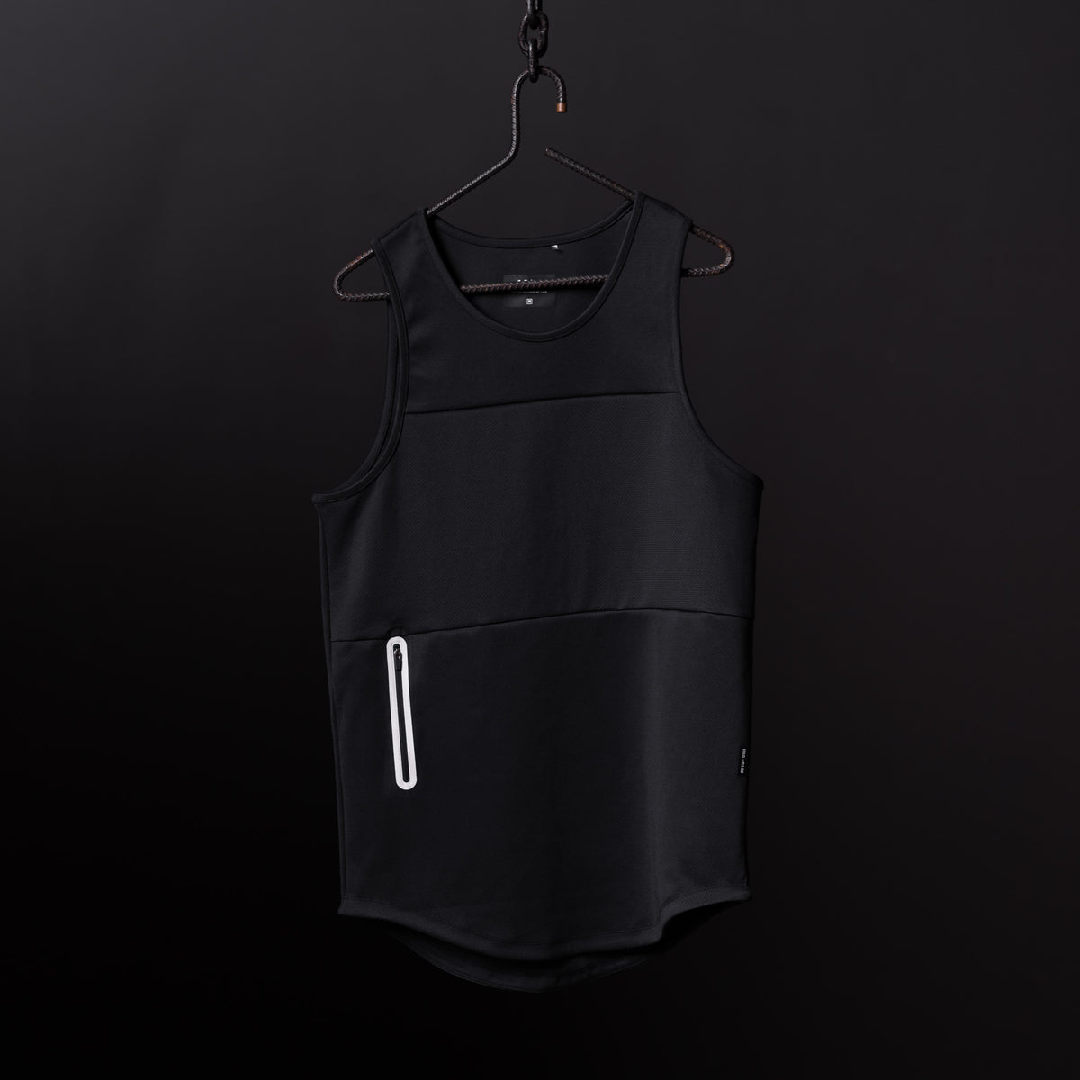 Black mesh utility tank on hanger against dark background, front view