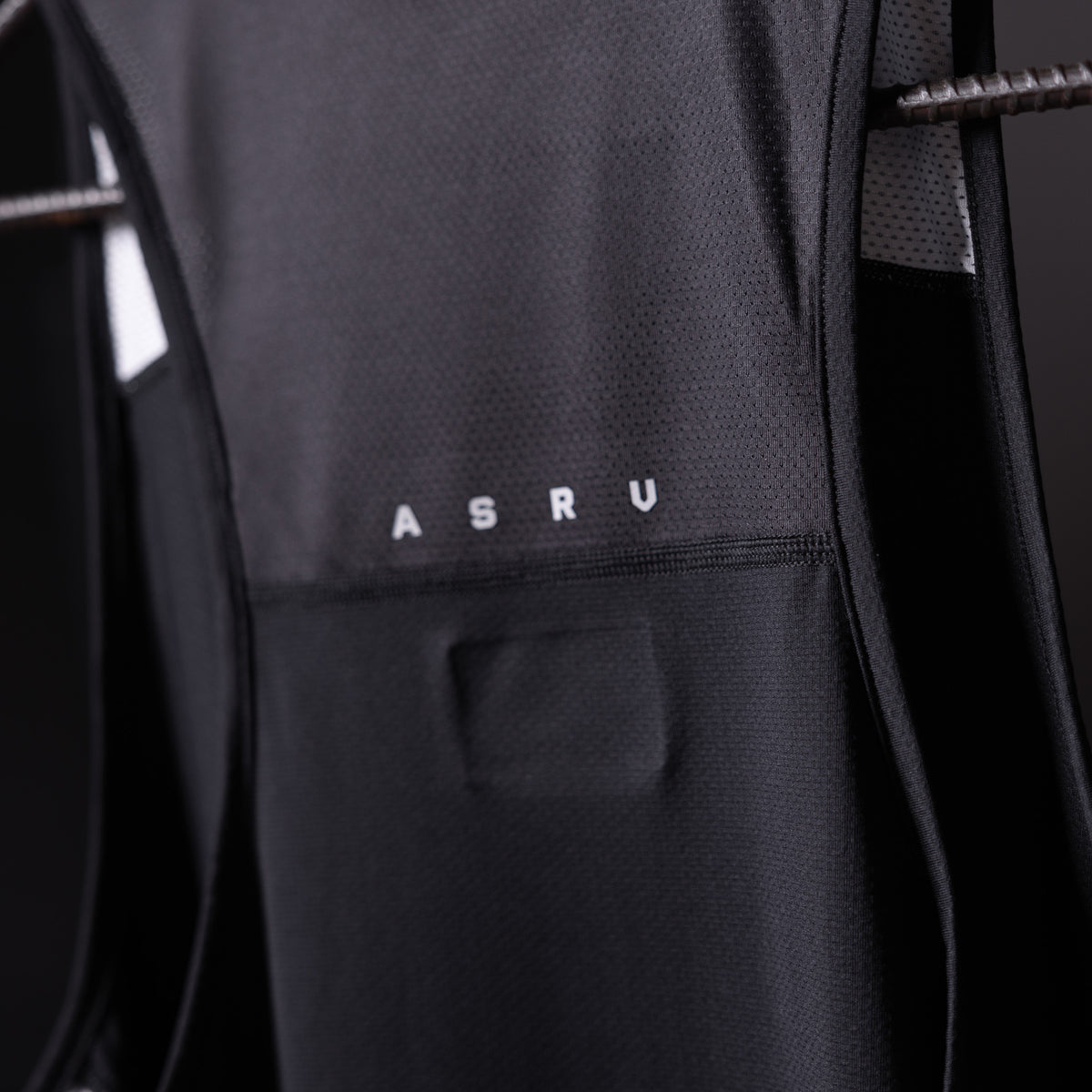 SM'19 Singlet Tank in black, close-up detail shot showing ASRU branding and fabric texture