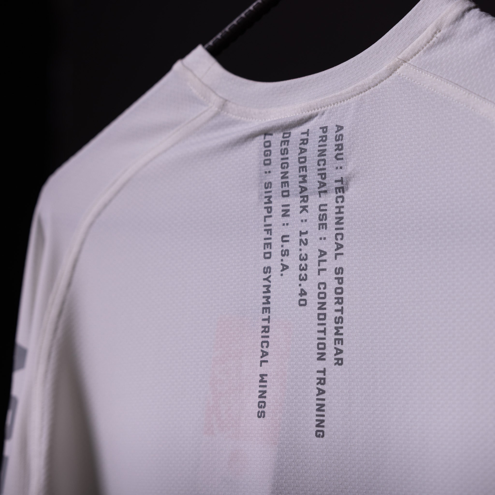 SP'20 Long Sleeve Shirt in white, closeup of chest graphic and care instructions