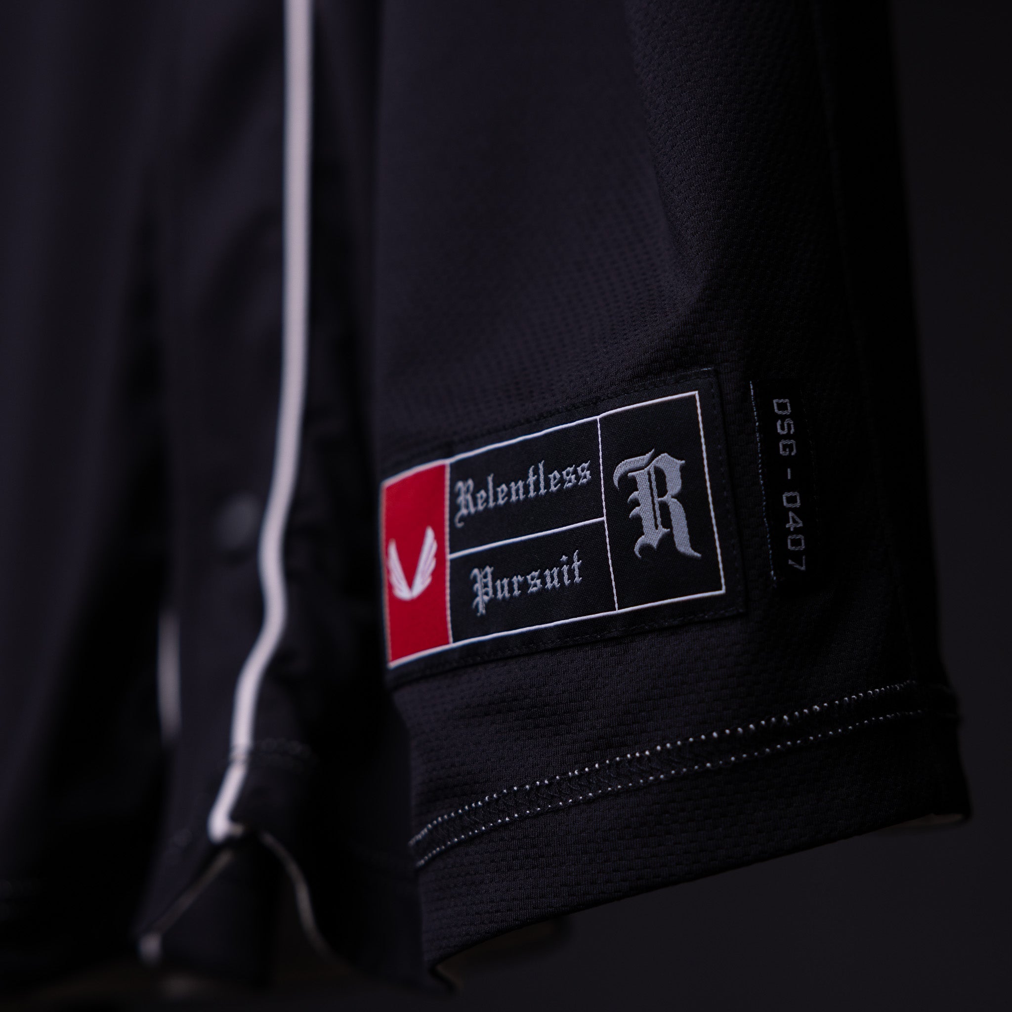 FA'21 Reversible Jersey label detail closeup showing Relentless Pursuit branding on black fabric