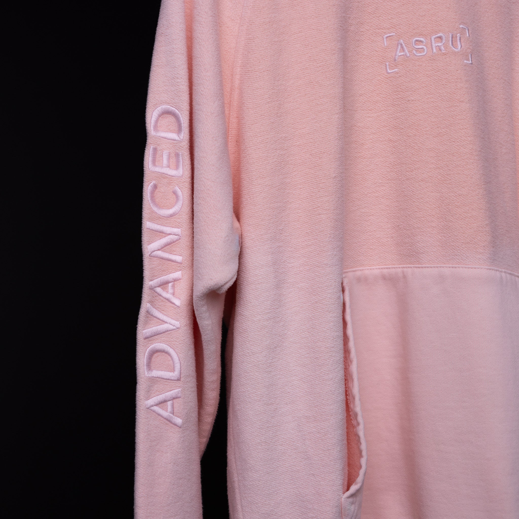 SS'20 Reverse Weave Hoodie in pink, detail shot of sleeve and chest branding