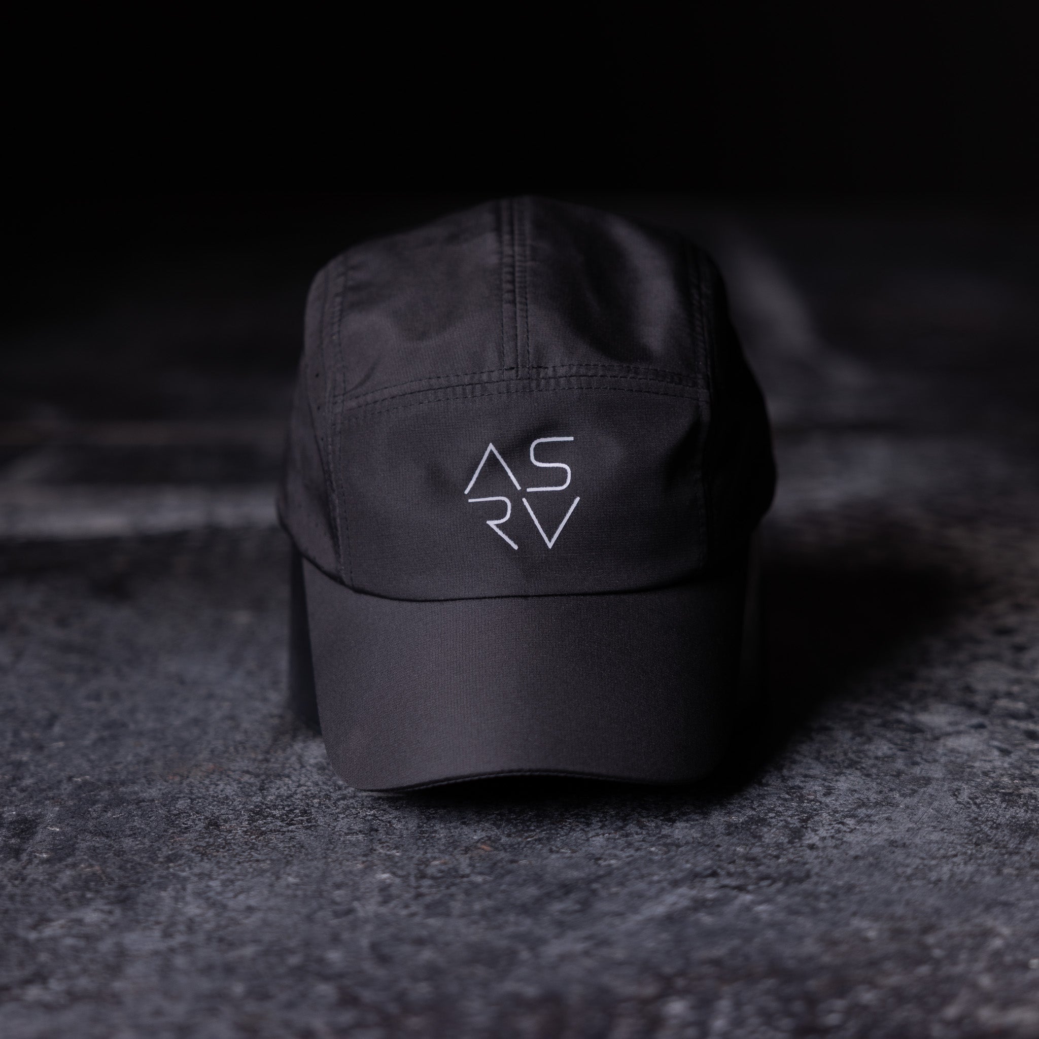 ASRV Vented Hat in black, angled front view on dark textured surface