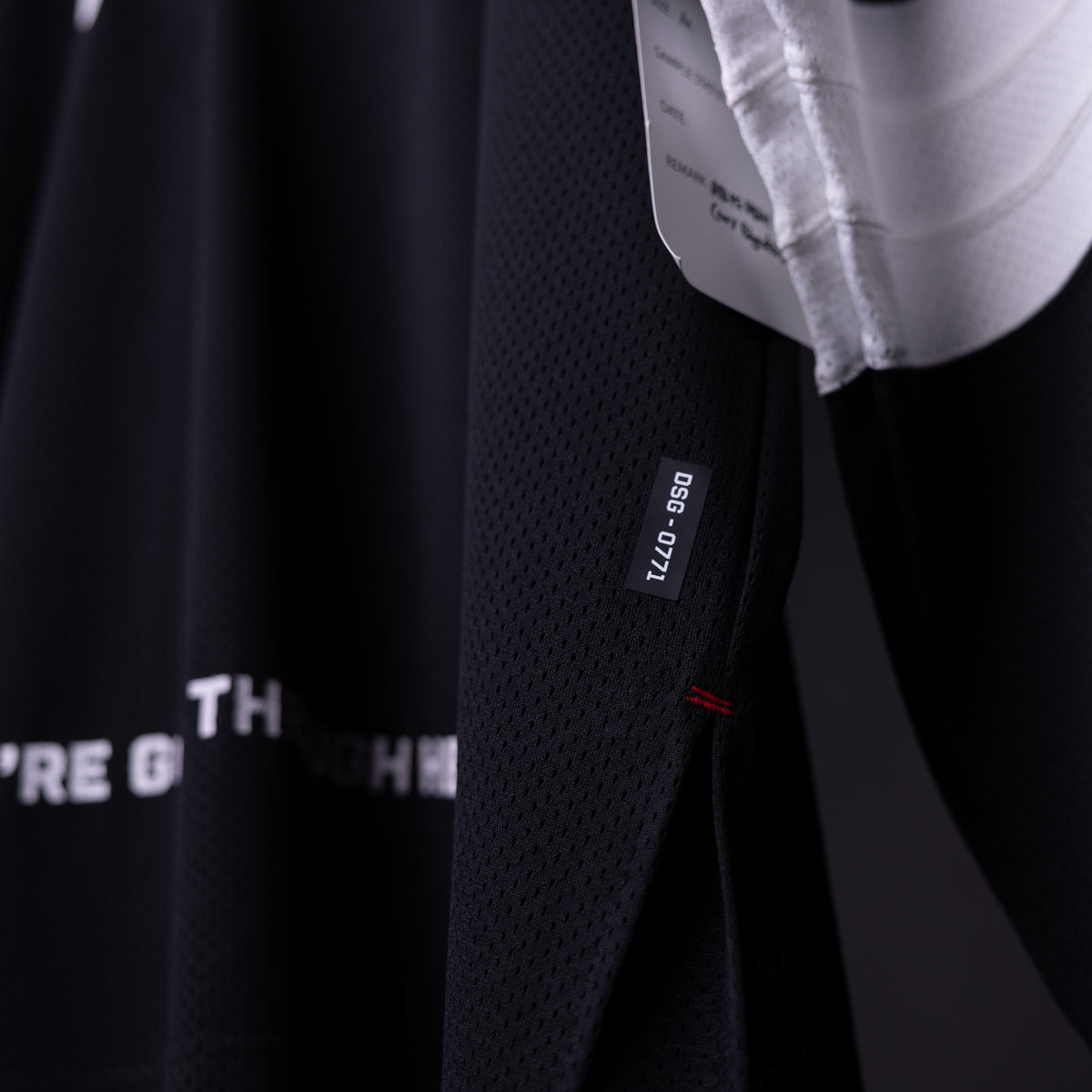 SM'23 Long-sleeve Jersey in black, detail shot of fabric texture and care label