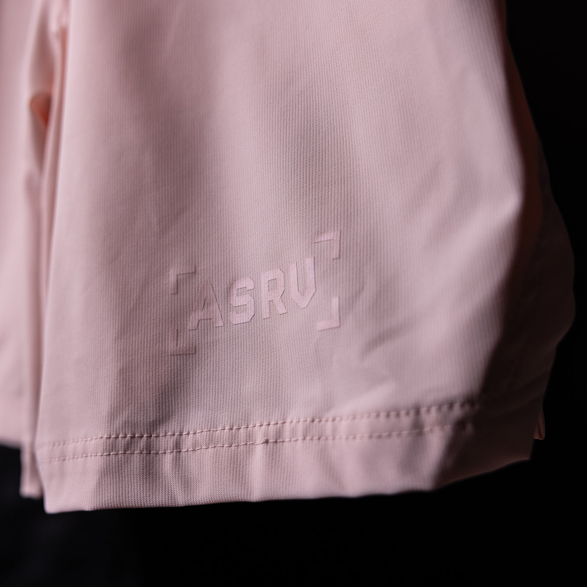SP'21 Coastal Training Short in pink, detail shot of side seam and branding