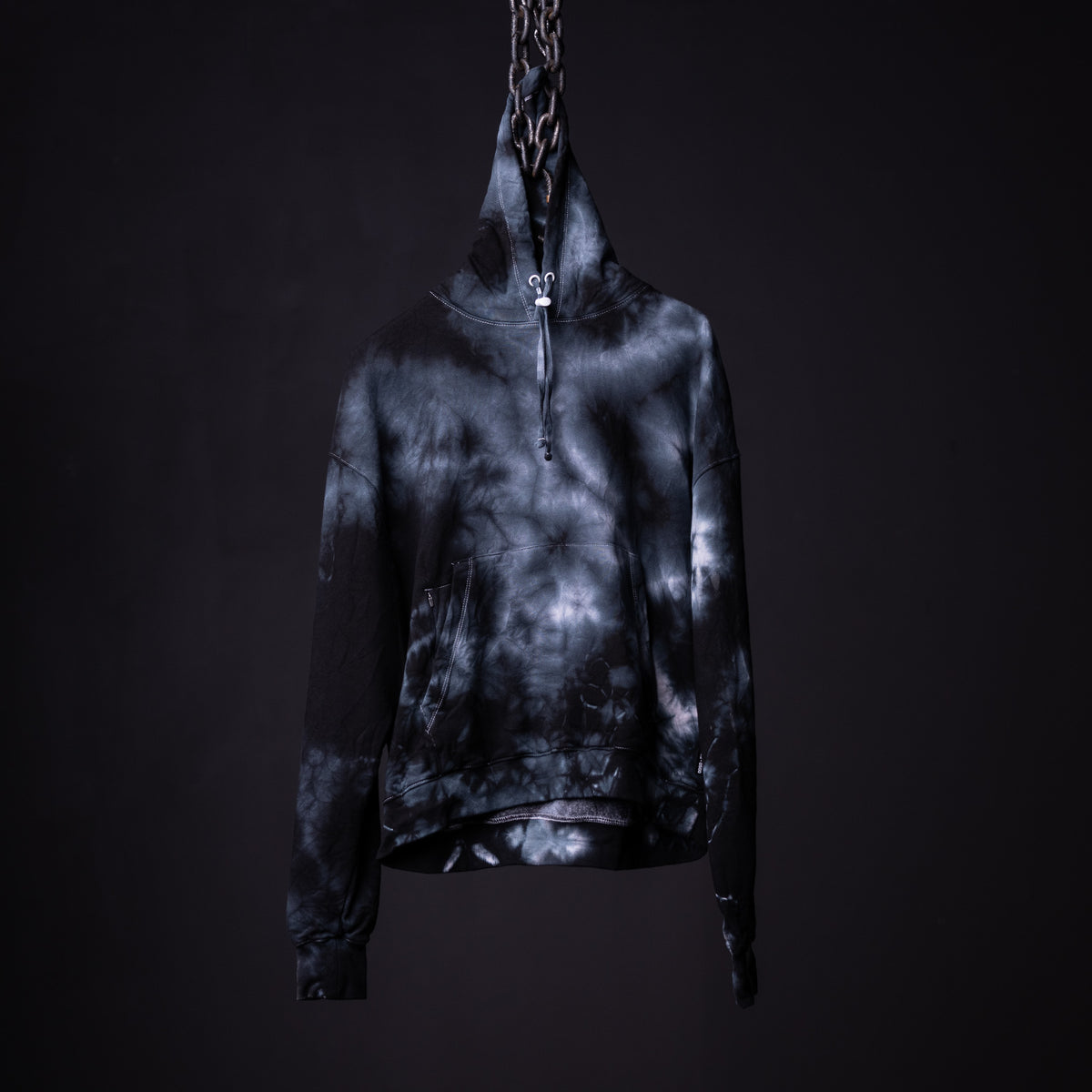 SM'22 Tie Dye Hoodie in black and white tie dye, displayed on mannequin against dark background