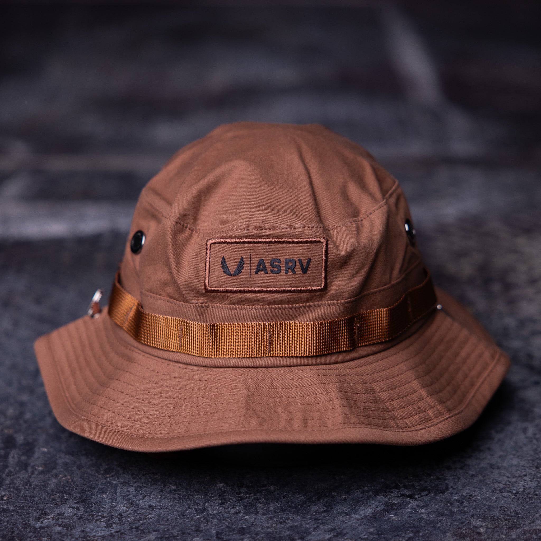 Flatlay clay boonie hat with ASRV logo and orange ribbon band, front view