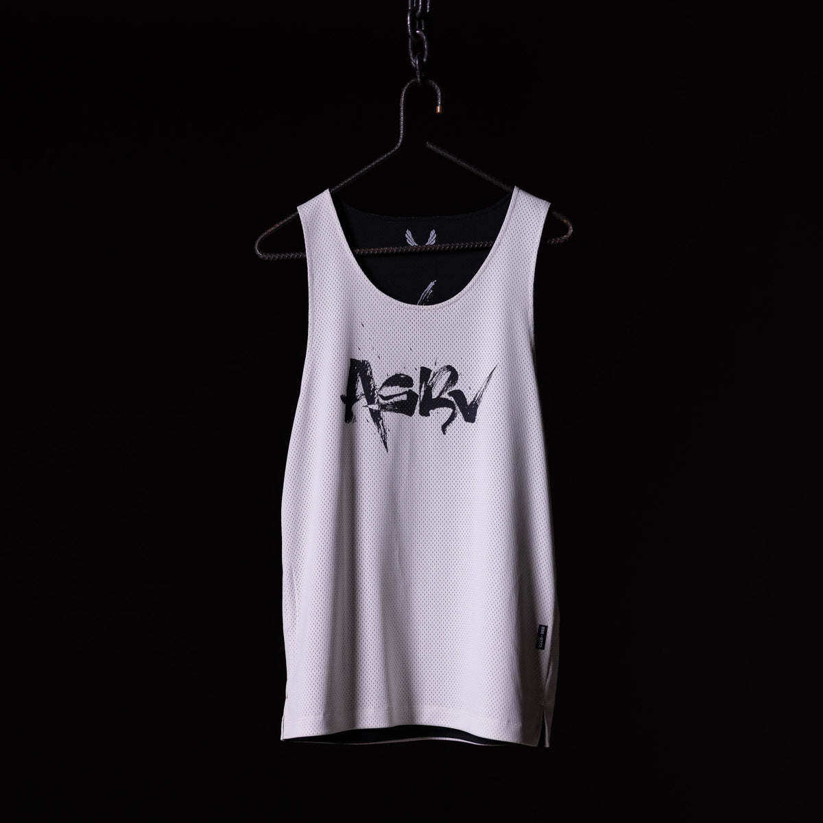SM'23 Mesh Reversible Pinnie in white, displayed on hanger against black background