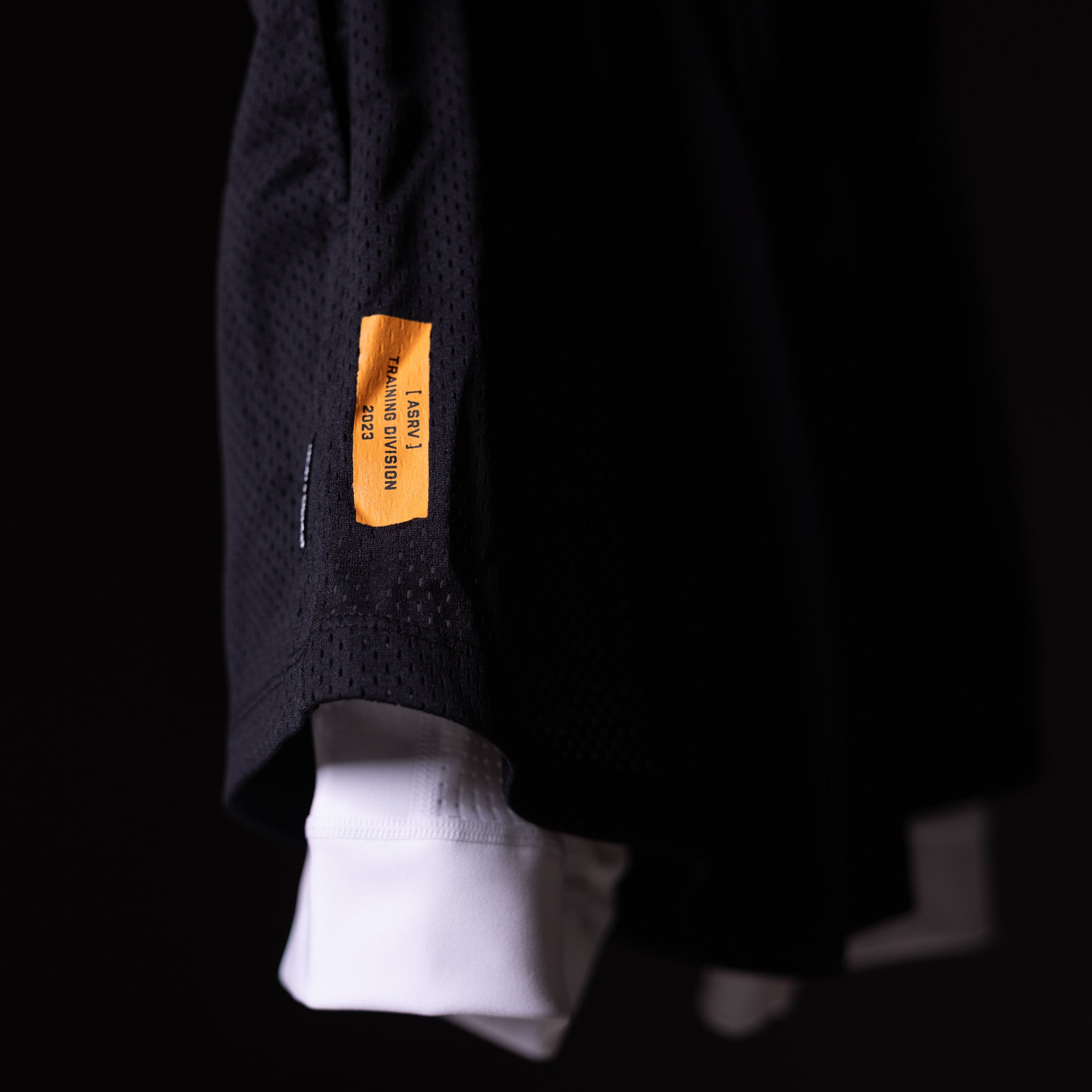 FA'23 Training Division Mesh Shorts in navy, worn with white socks, detail shot of label