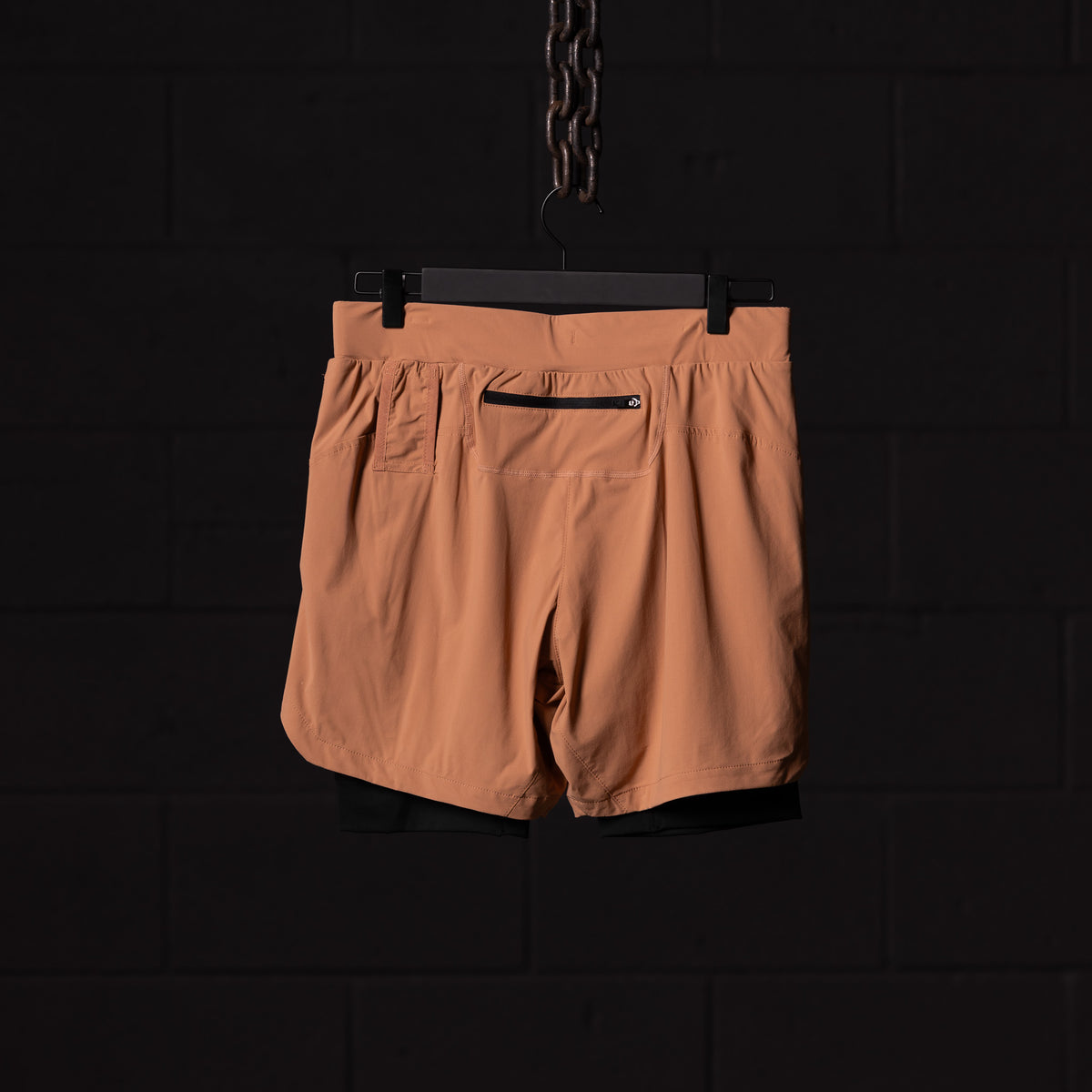 FA'22 7" Liner Short in tan/caramel, back view on hanger