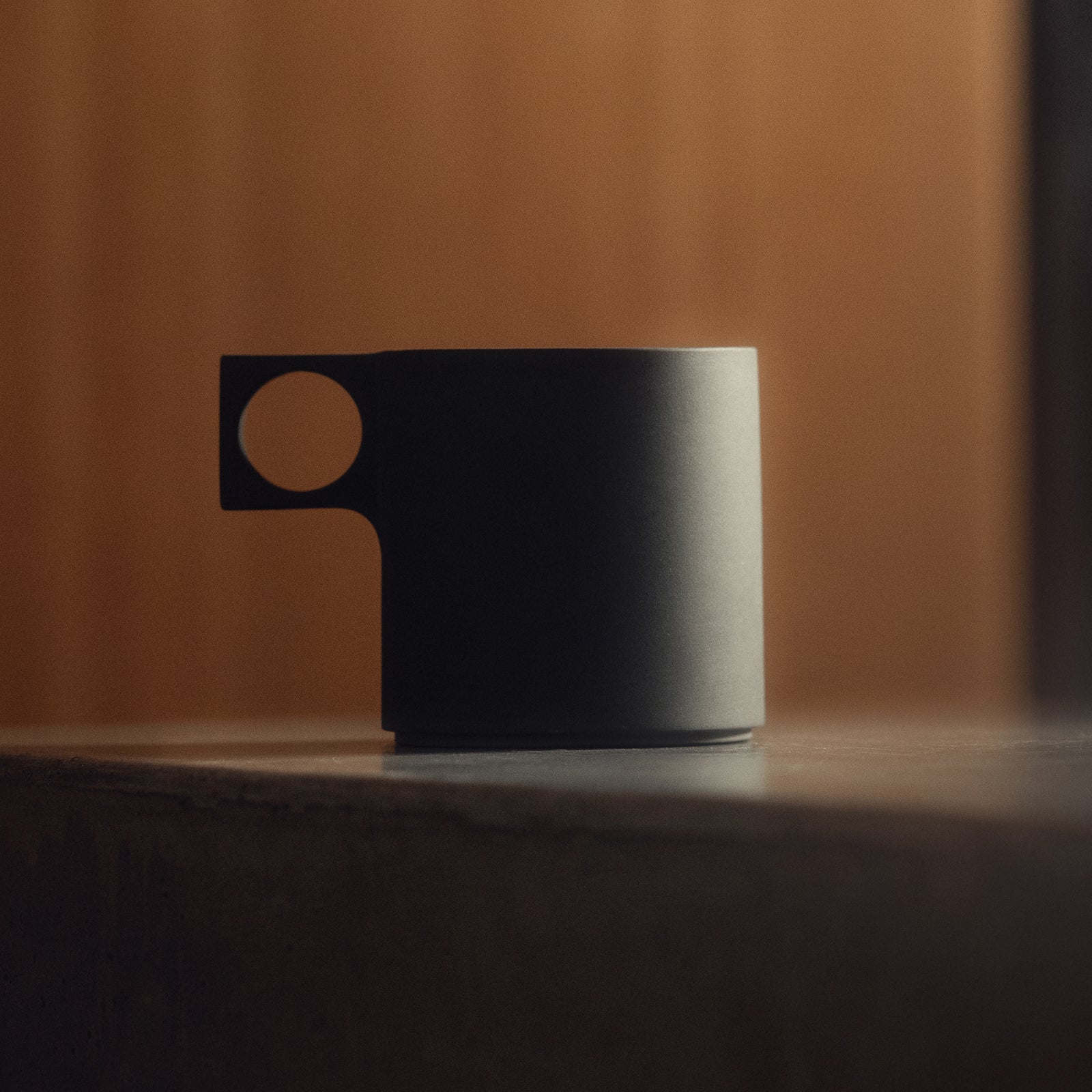 ASRV x Walden ceramic mug in black with tan handle, side view