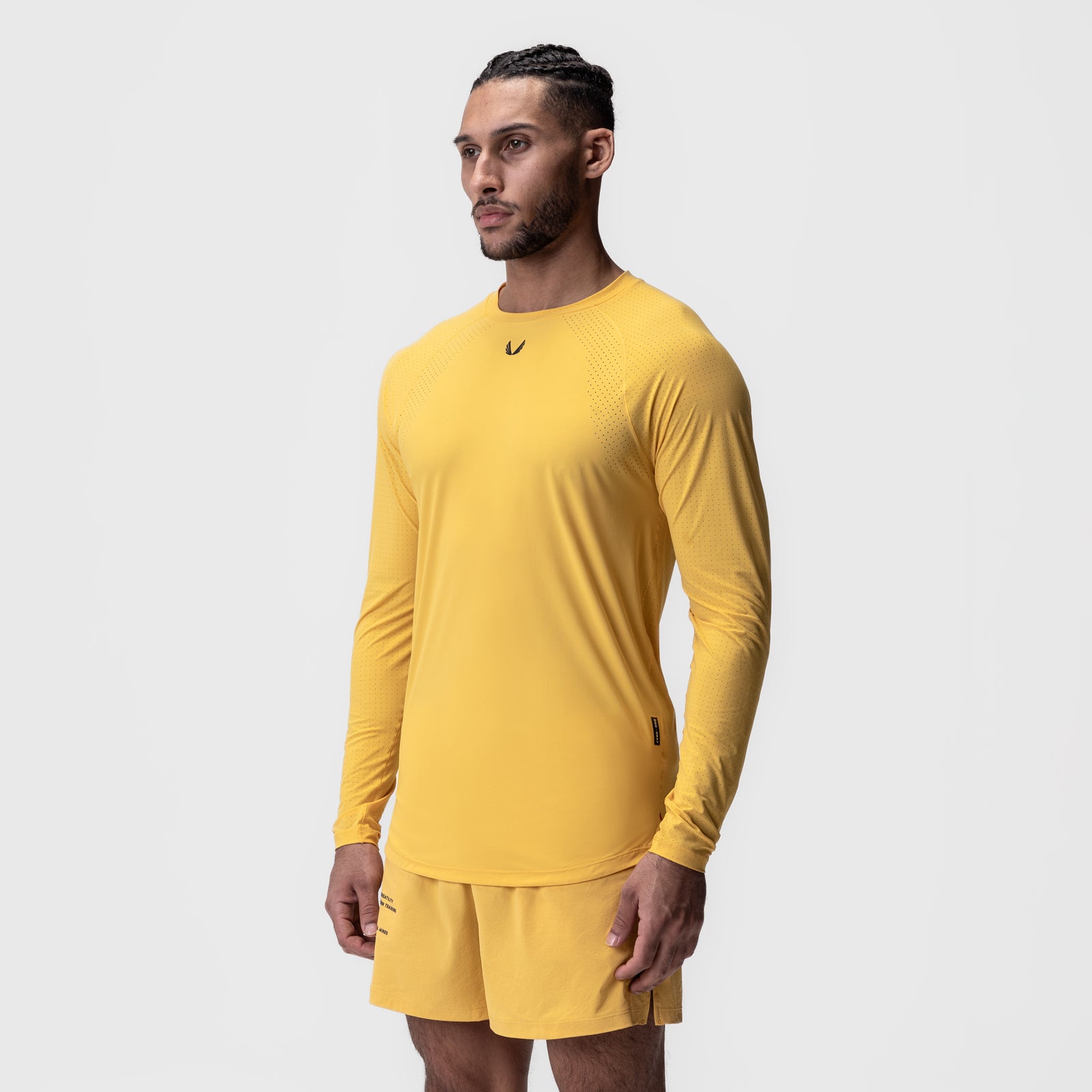 Laser-Vent Established Long Sleeve in amber yellow, modeled standing sideways