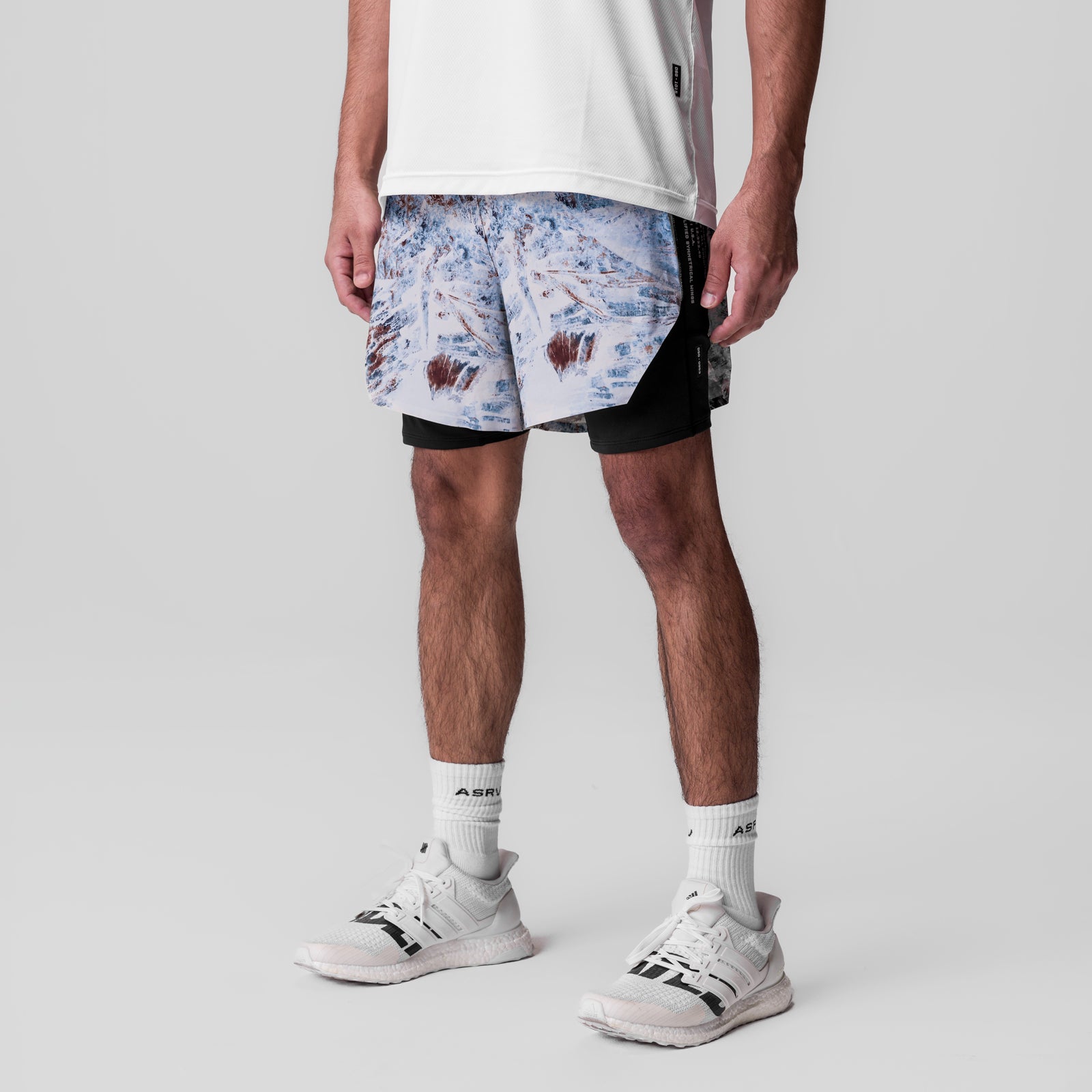 Aerotex Hybrid Liner Short in blue Realtree Aspect camo with black liner, worn with white socks and sneakers