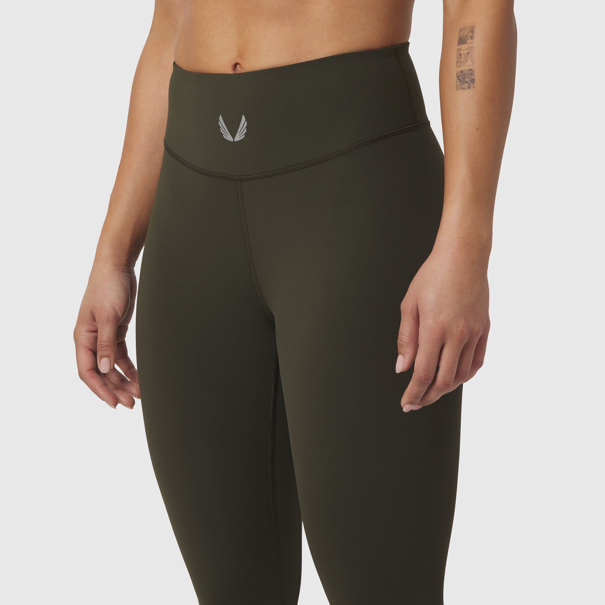 W002 LYCRA® ADAPTIV Legging in olive, worn by model, front waist detail view