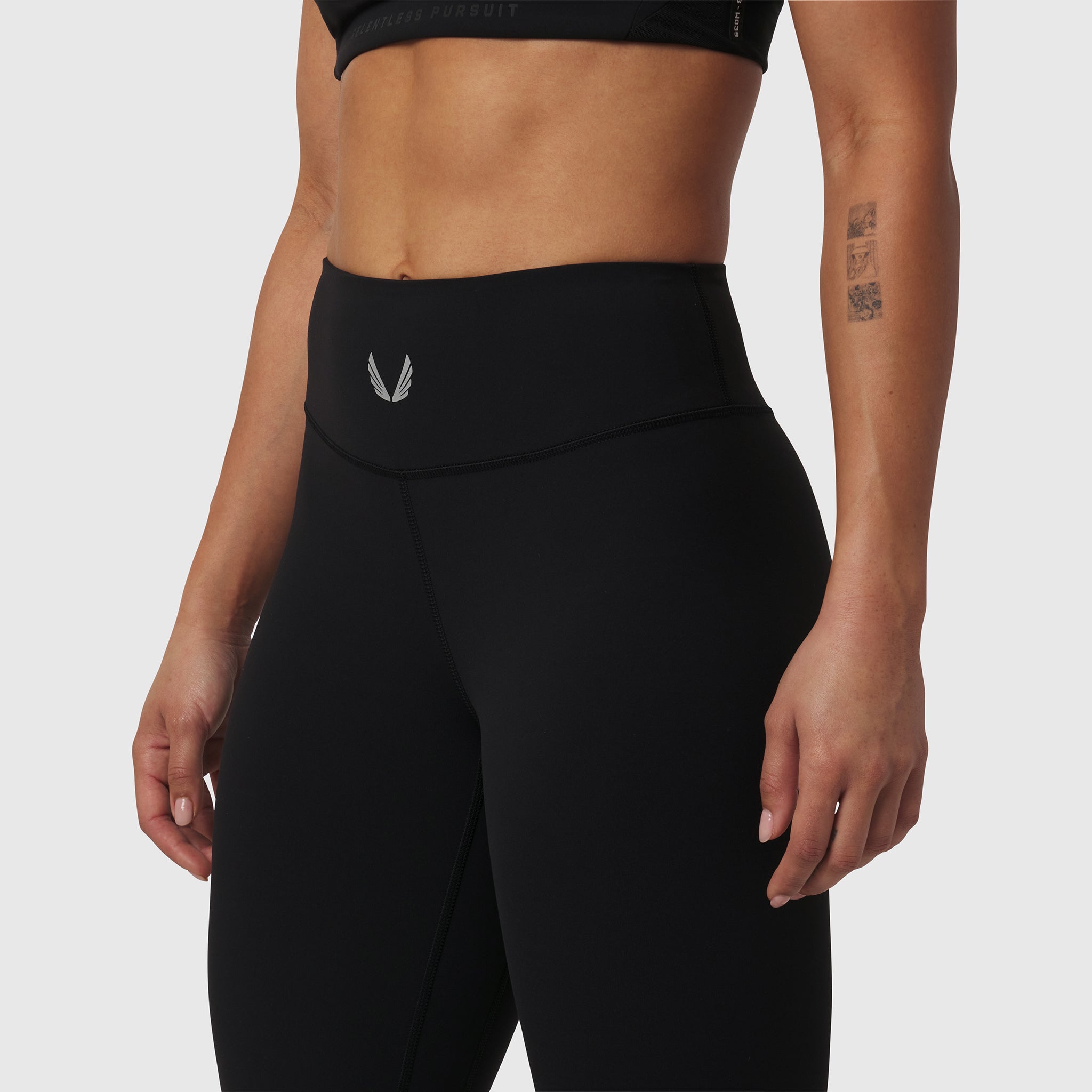 Black LYCRA® ADAPTIV legging on model, waist-down side view