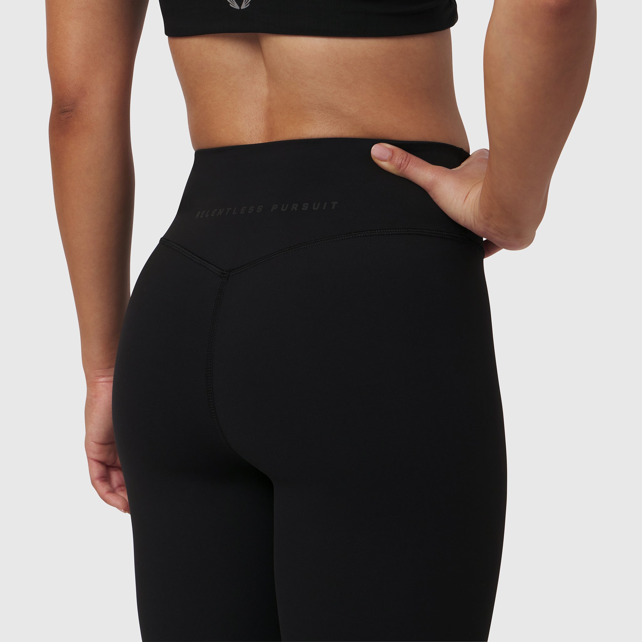 W002. LYCRA® ADAPTIV Legging in black, model wearing leggings from back view