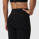 W002. LYCRA® ADAPTIV Legging in black, model wearing leggings from back view