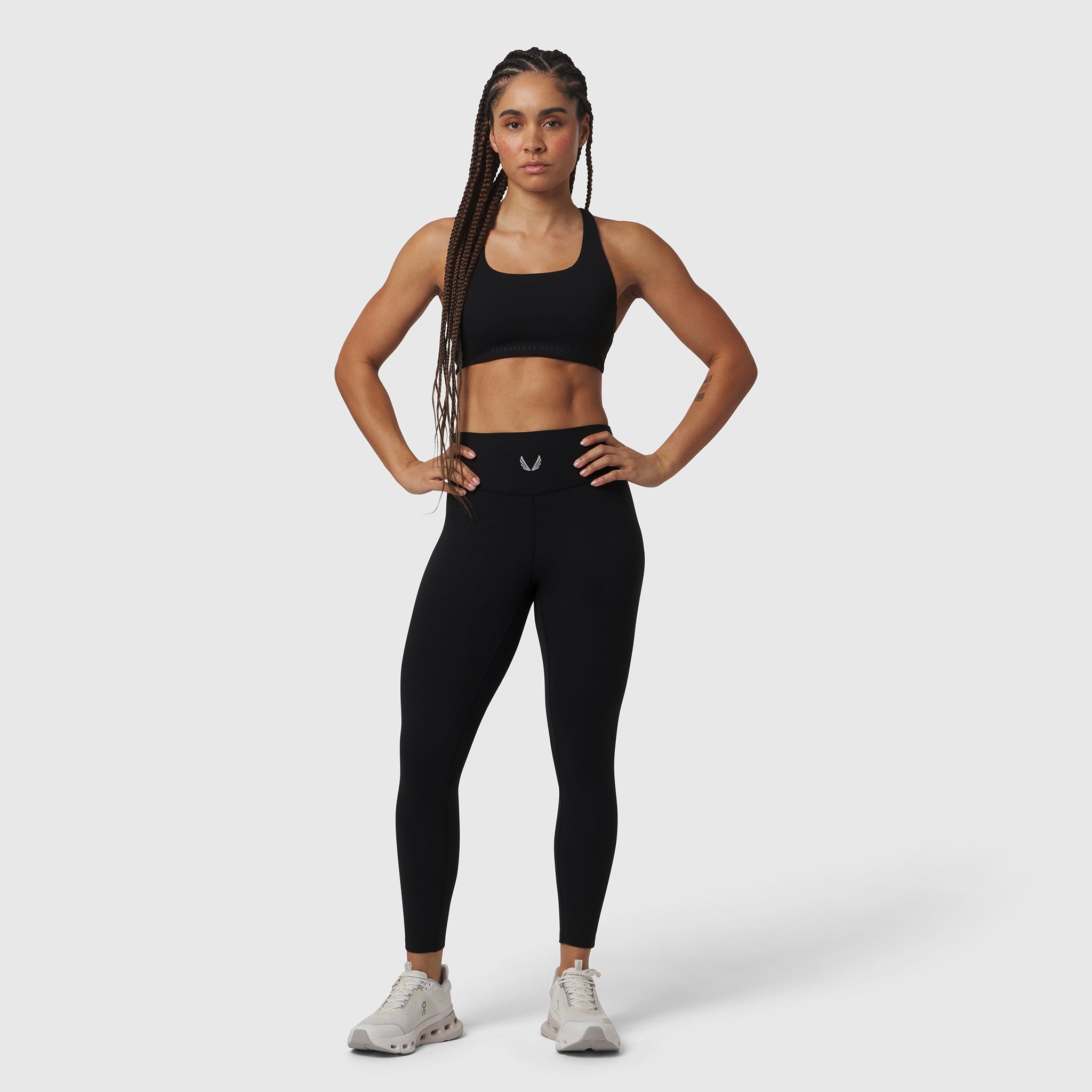 W002 LYCRA® ADAPTIV Legging in black, worn by model in athletic pose