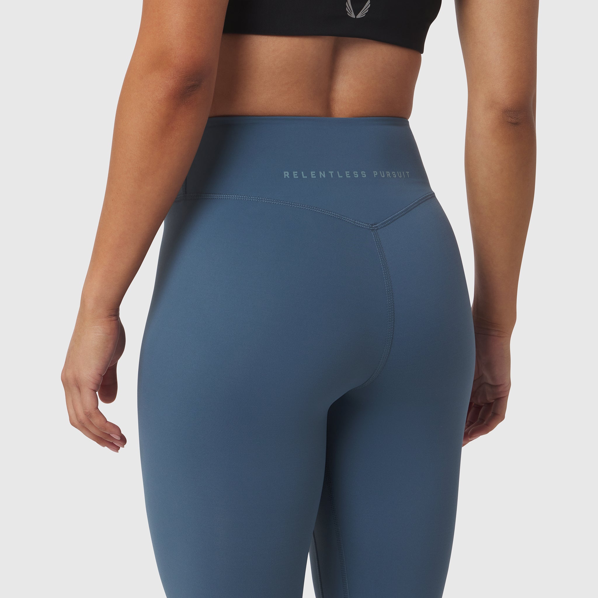 W002 LYCRA® ADAPTIV Legging in Storm blue, worn by model, back view