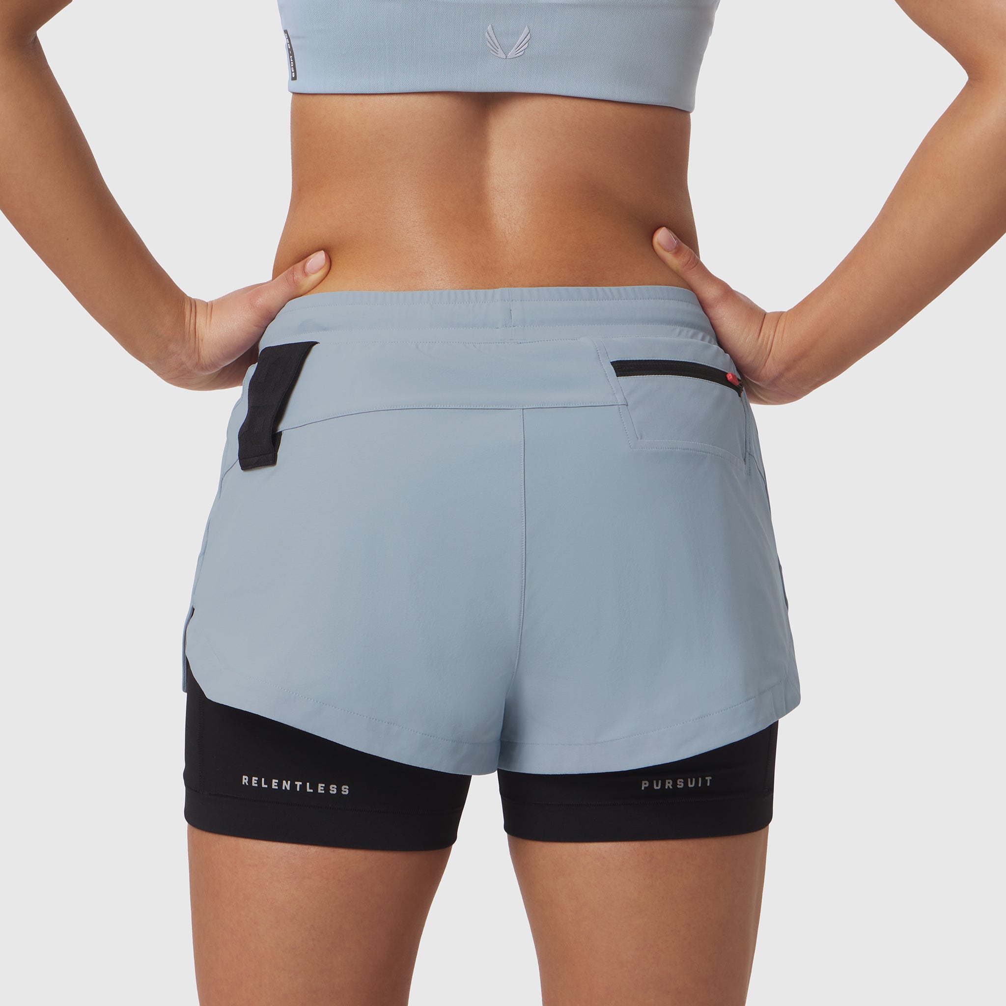 W025 Tetra-Lite Liner Short in light sky, back view on model