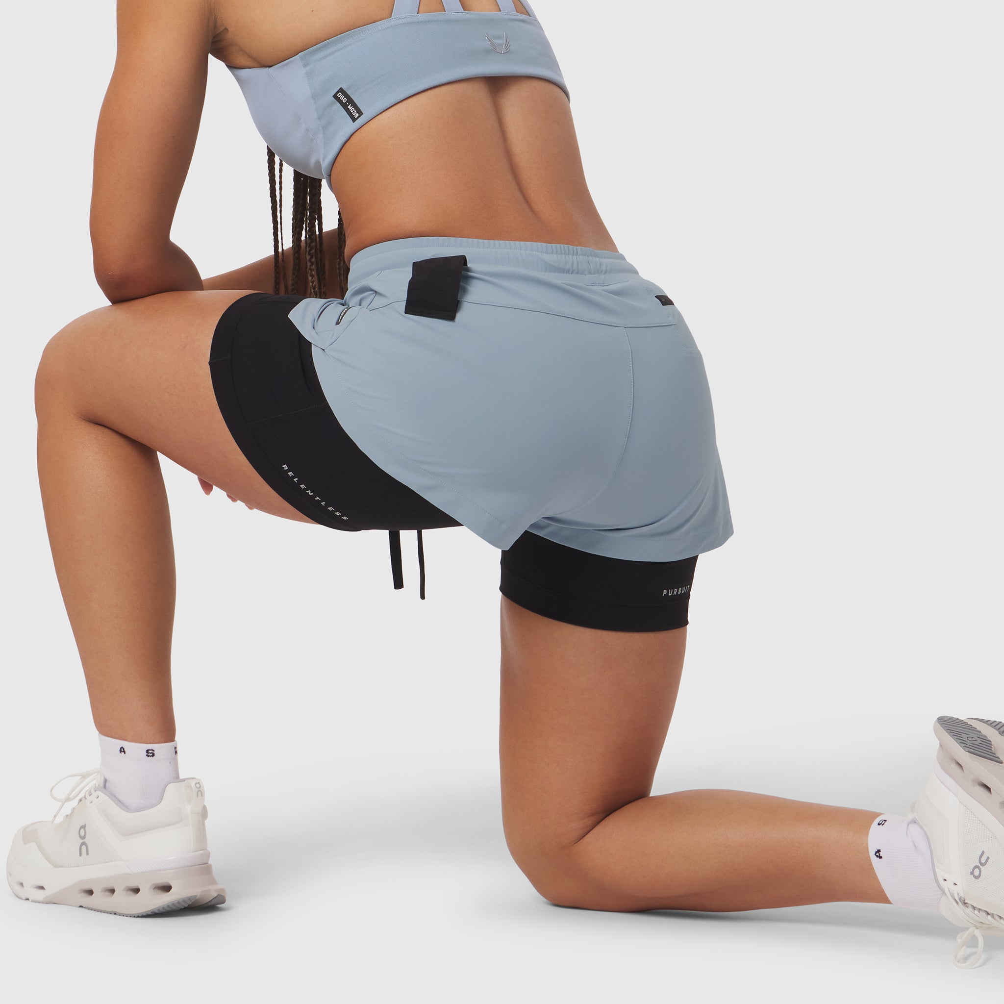 Tetra-Lite® Liner Short in light sky and black, worn by model kneeling on white background