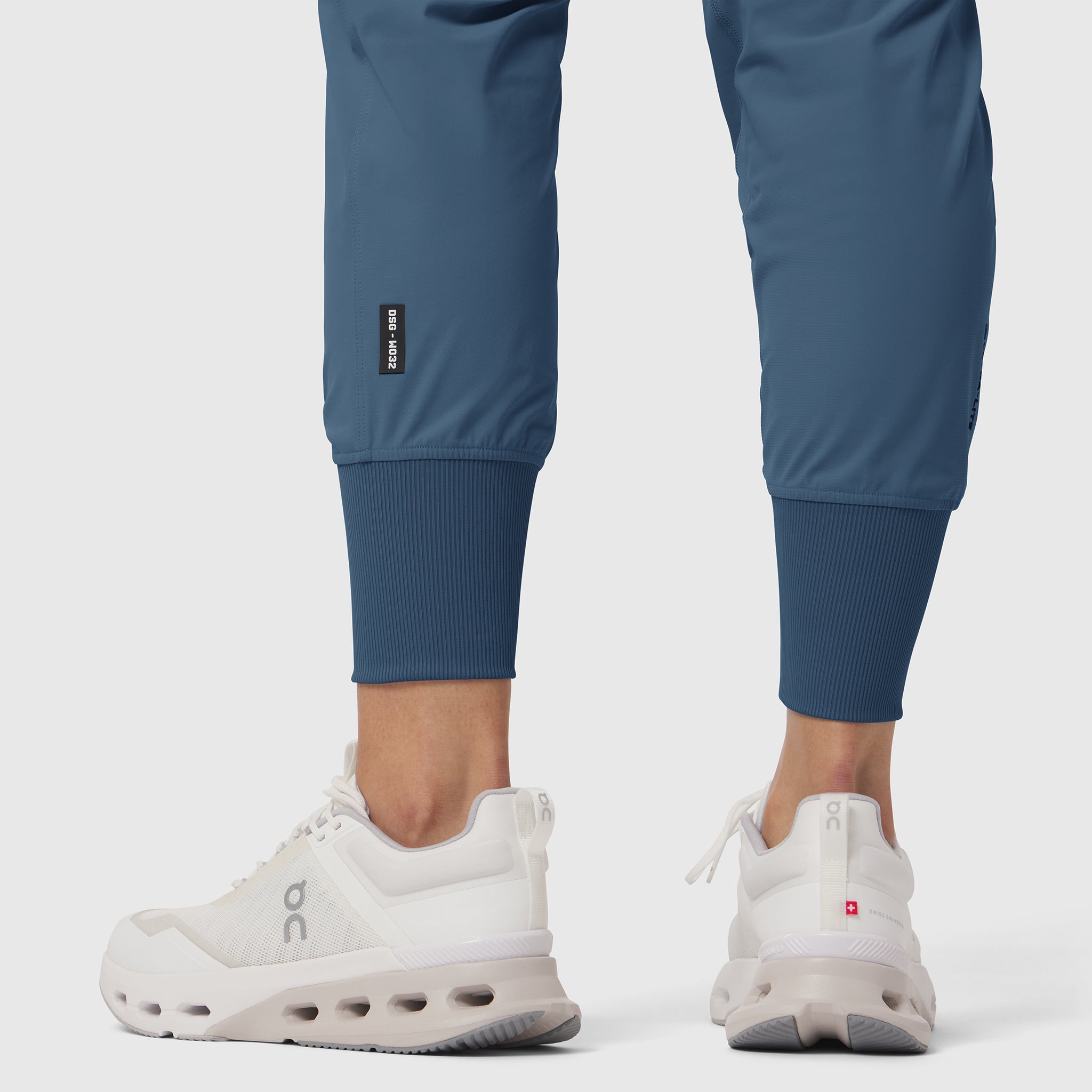 W032 Tetra-Lite Cargo High Rib Jogger in storm blue, modeled from waist down with white sneakers