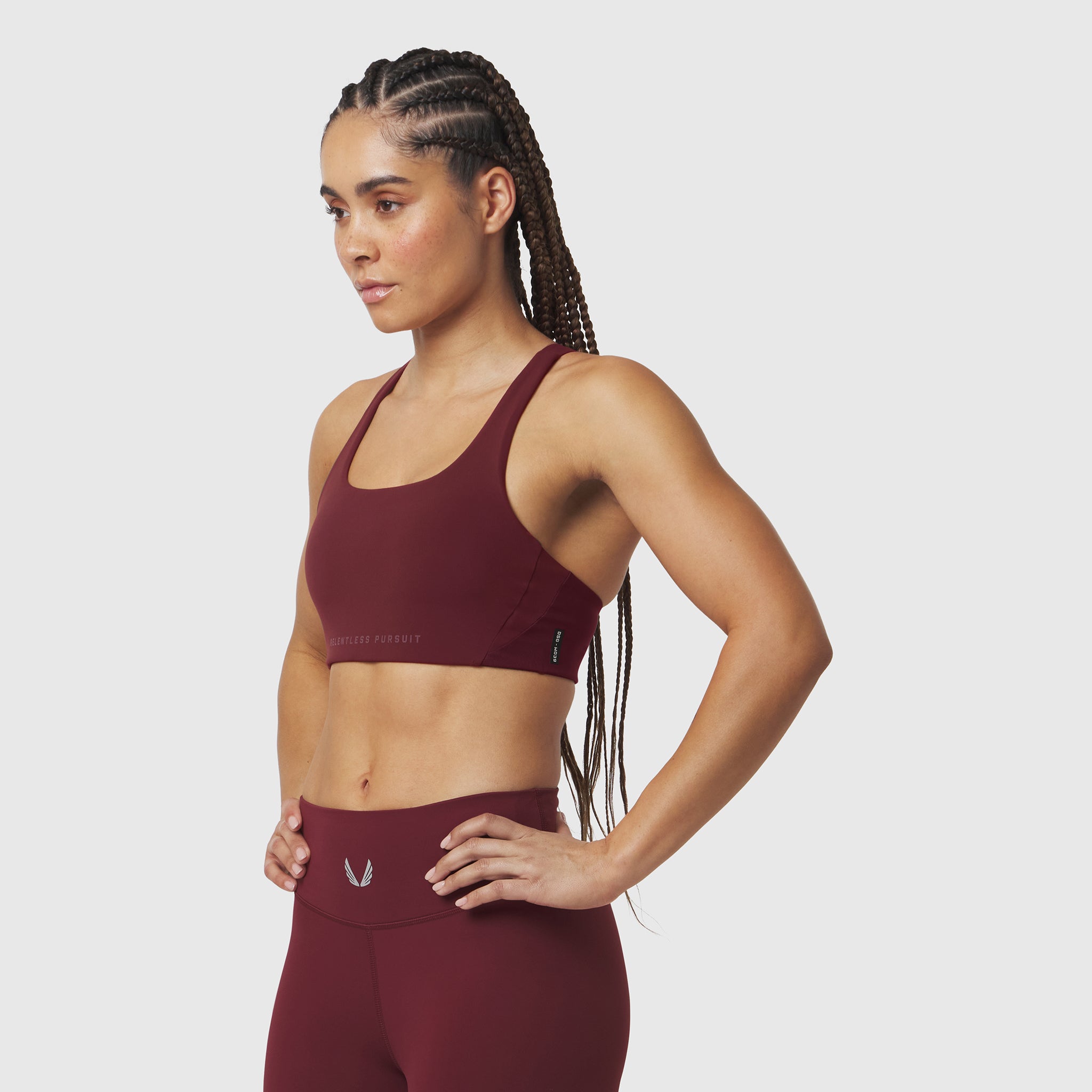 Crimson LYCRA® Hybrid Sports Bra worn by model, side view