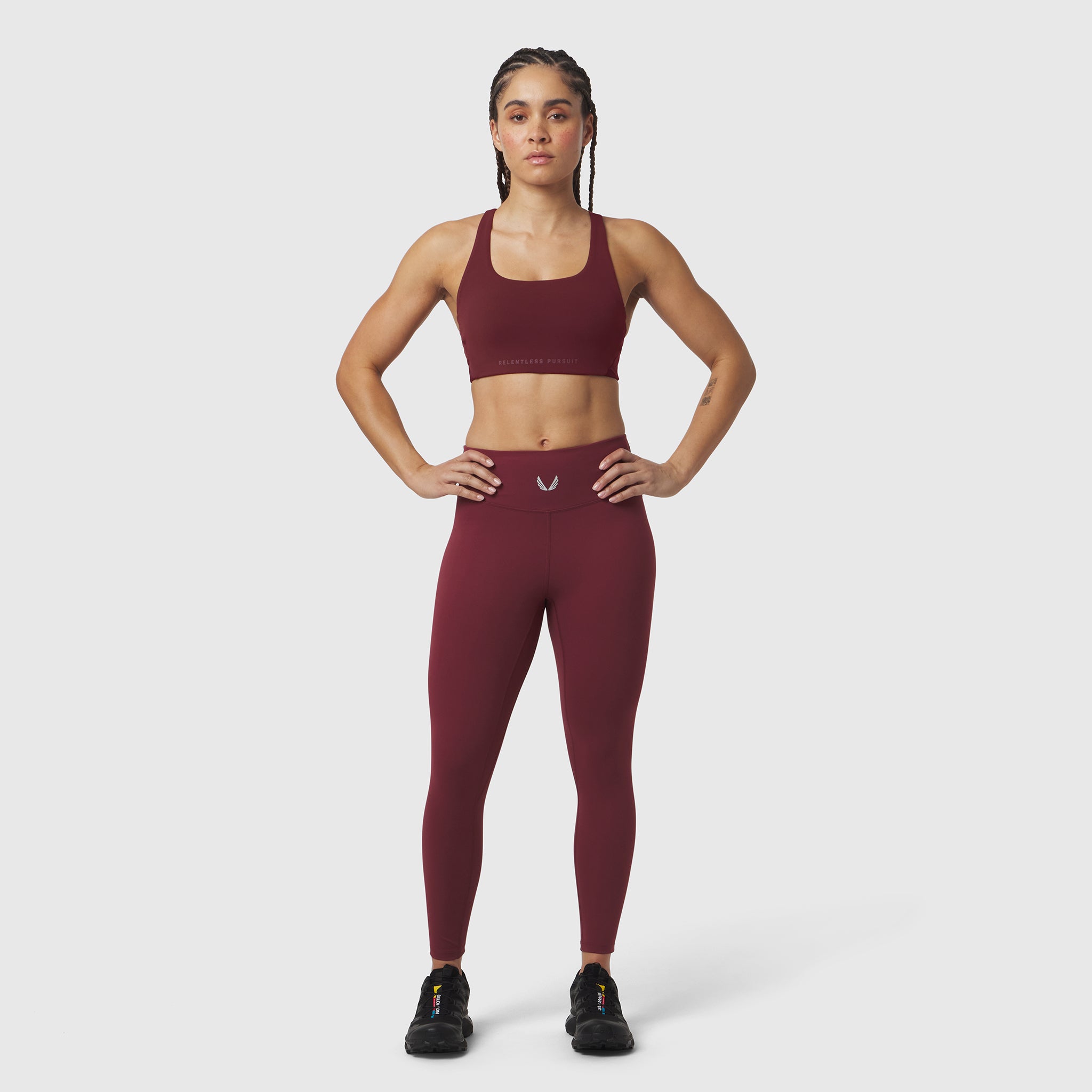 W039 Lycra Hybrid Sports Bra in crimson, worn by model in front pose