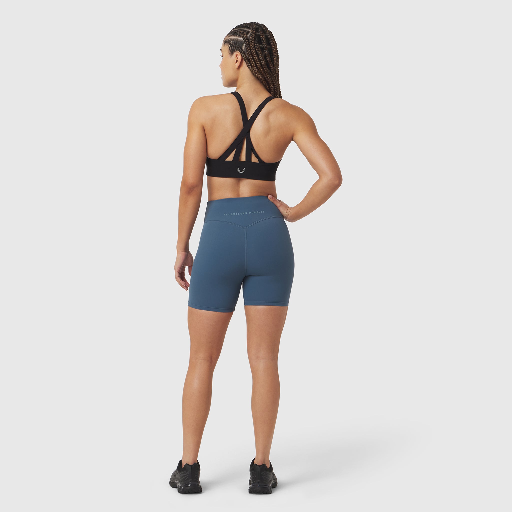LYCRA® ADAPTIV Biker Short in storm blue, worn by model shown from back