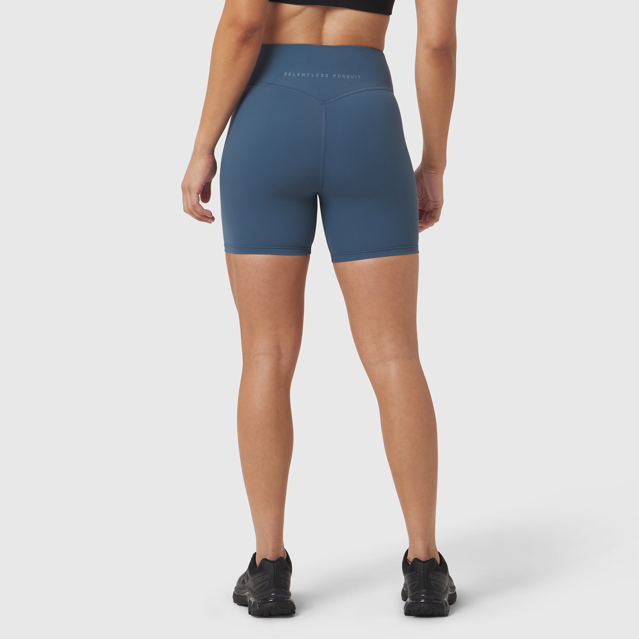 LYCRA® ADAPTIV Biker Short in storm blue, worn by model shown from behind