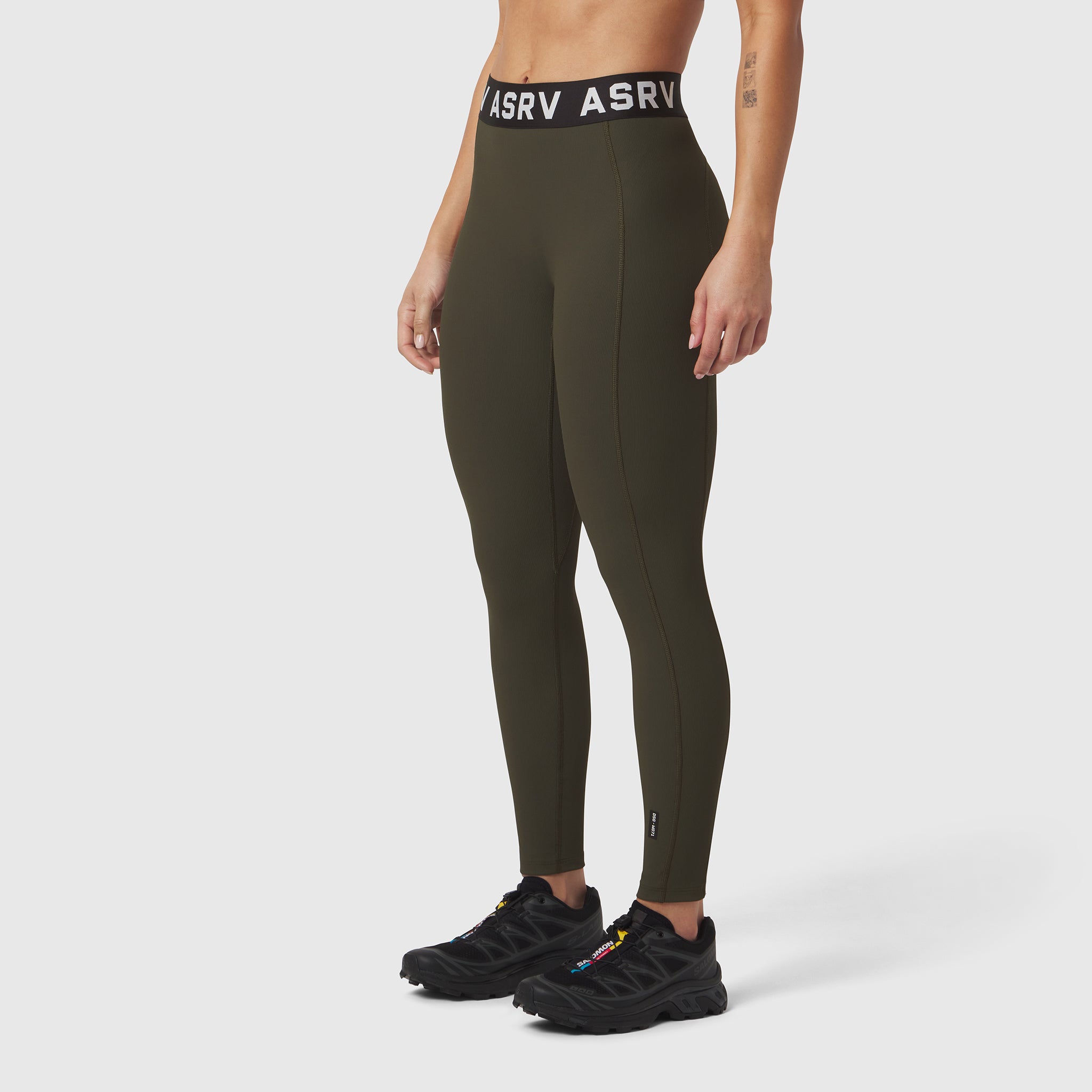 W071 Lycra Ribbed Legging in olive, modeled with black sneakers, side view