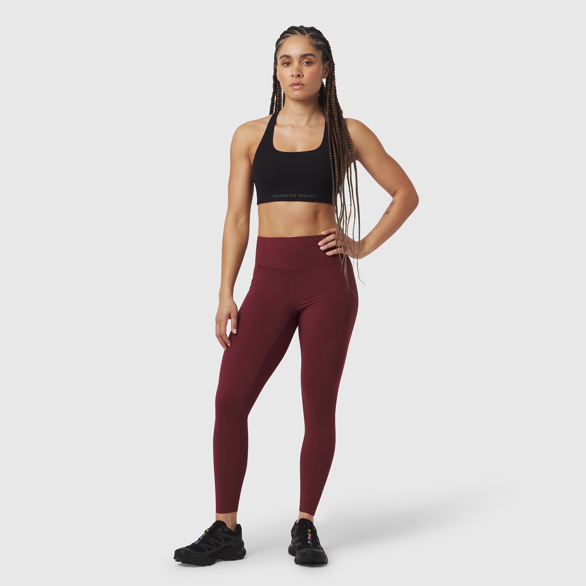 W072 LYCRA® ADAPTIV 4 Pocket Legging in crimson, worn by model with black sports bra
