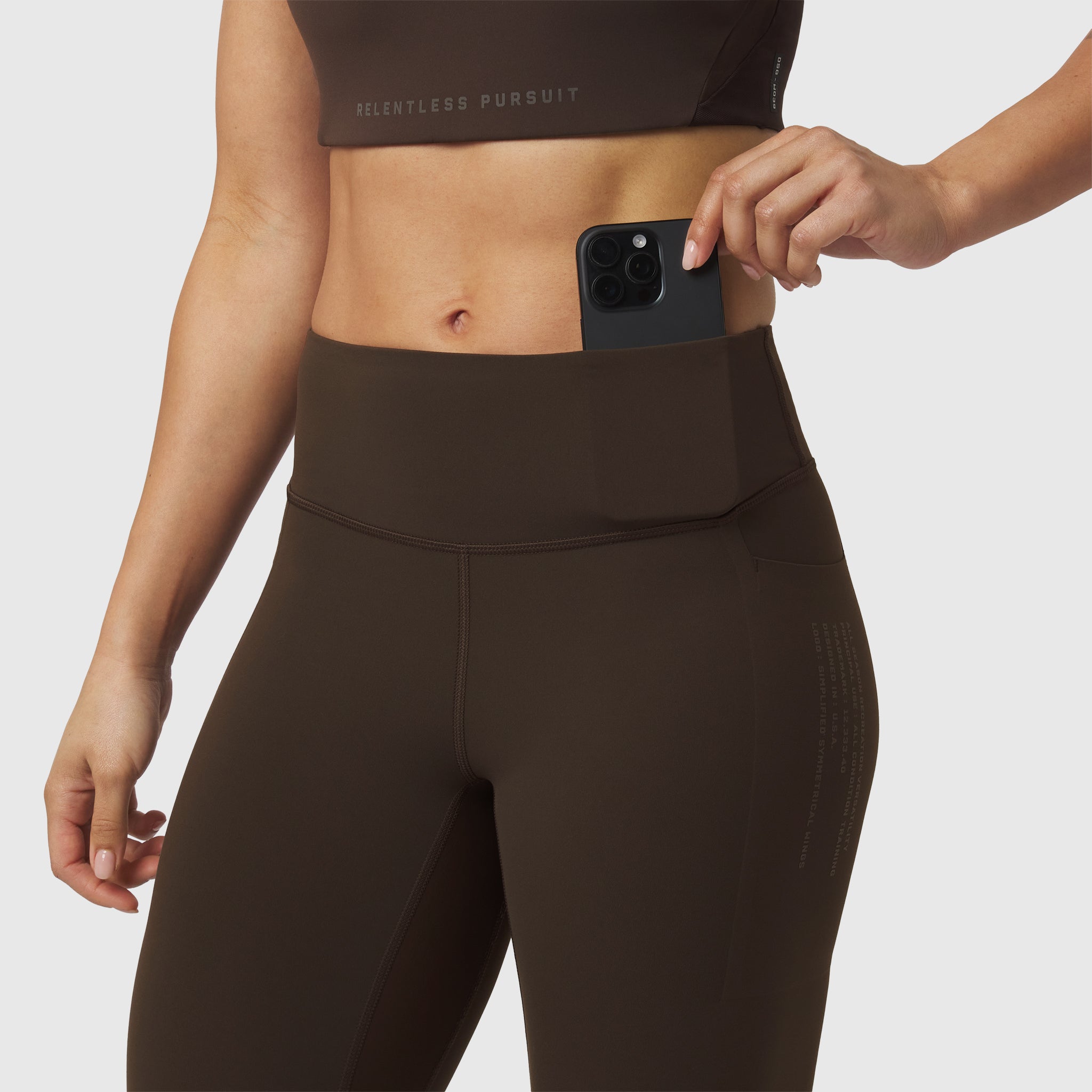 W072 LYCRA® ADAPTIV 4 Pocket Legging in Dark Earth, worn with phone in waistband pocket